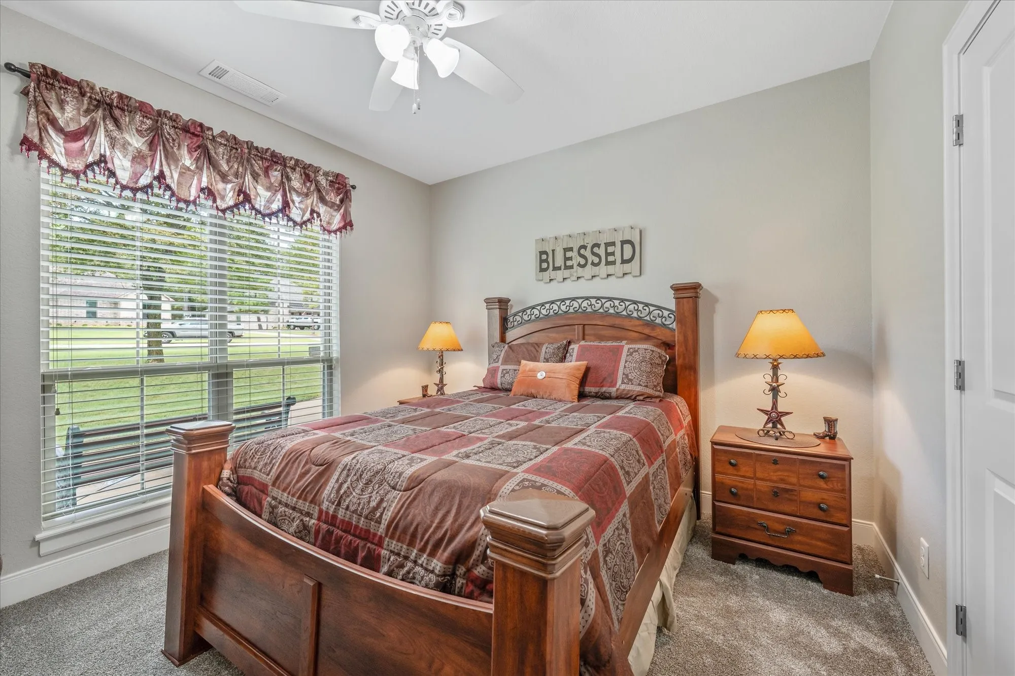 Wall-to-wall carpeting with light gray walls and a white ceiling fan