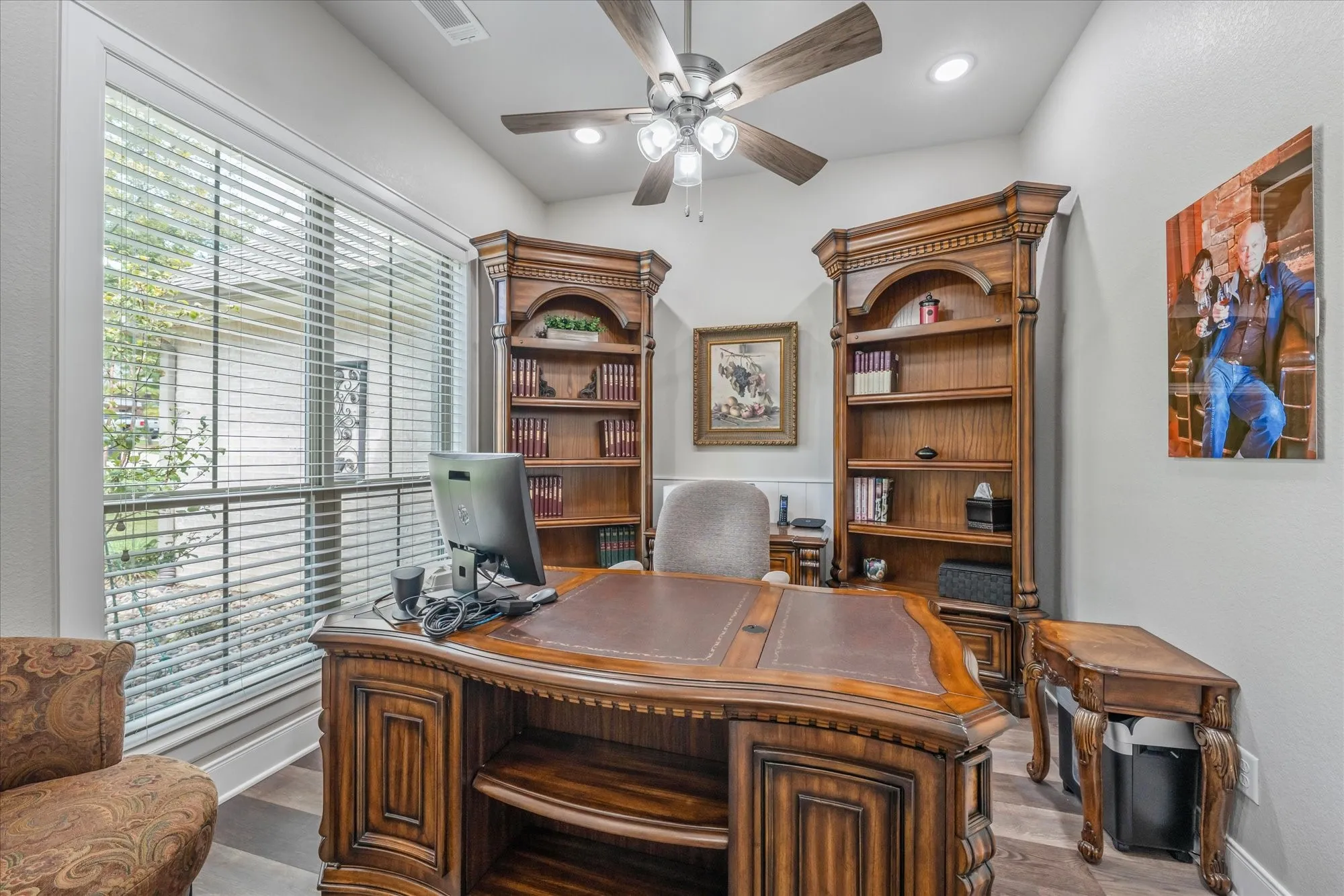 Recessed lighting, wood-finish flooring, and a ceiling fan with light fixture