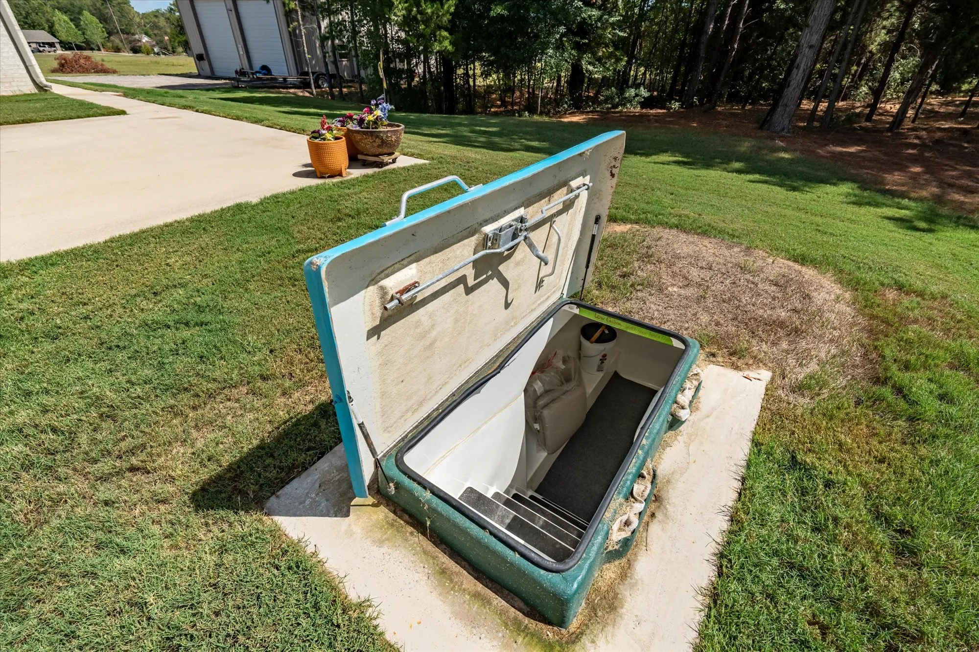 Subterranean access point featuring interior steps and a robust entry hatch