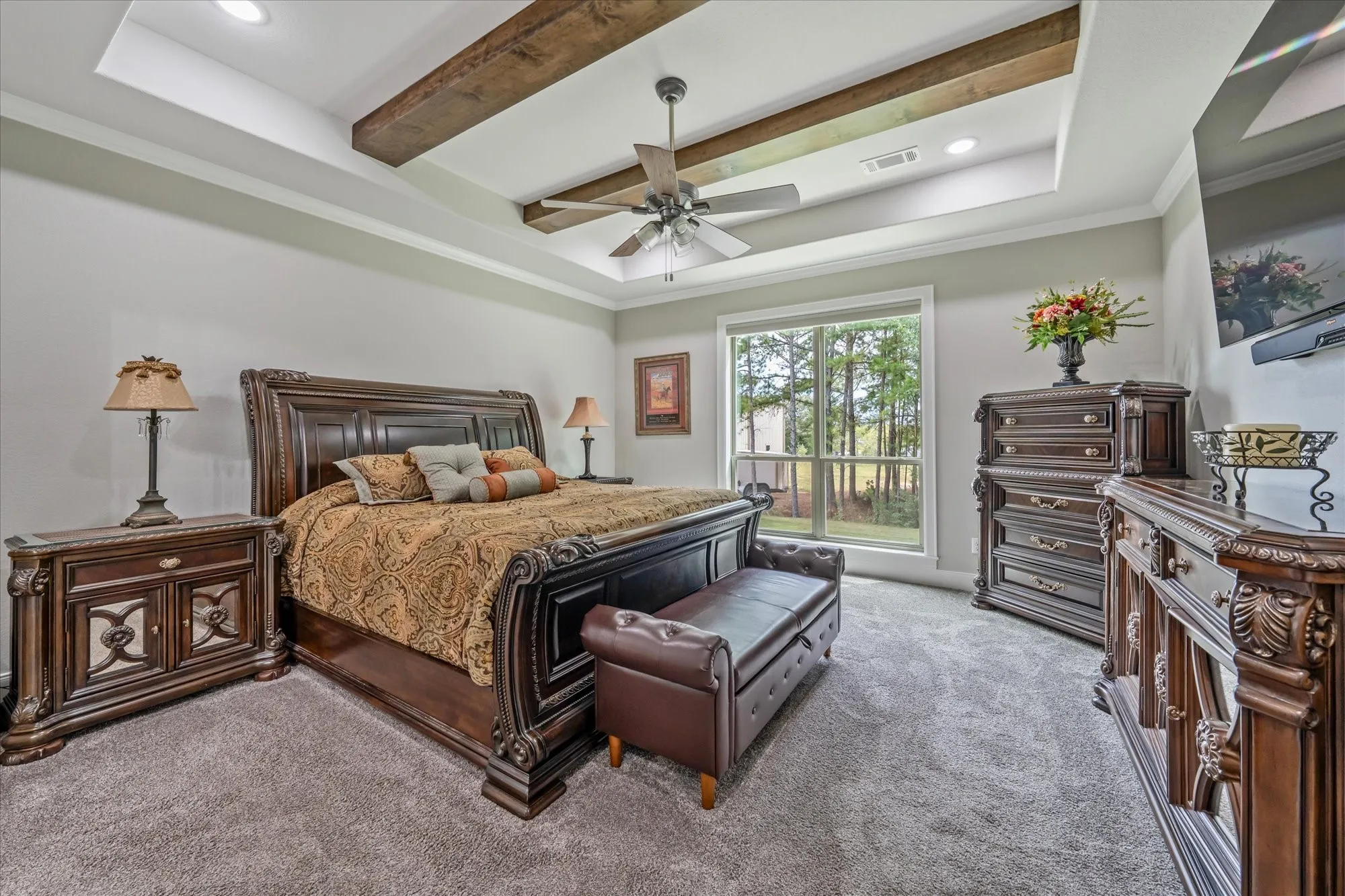 Tray ceiling with recessed lighting and wood-finish beams