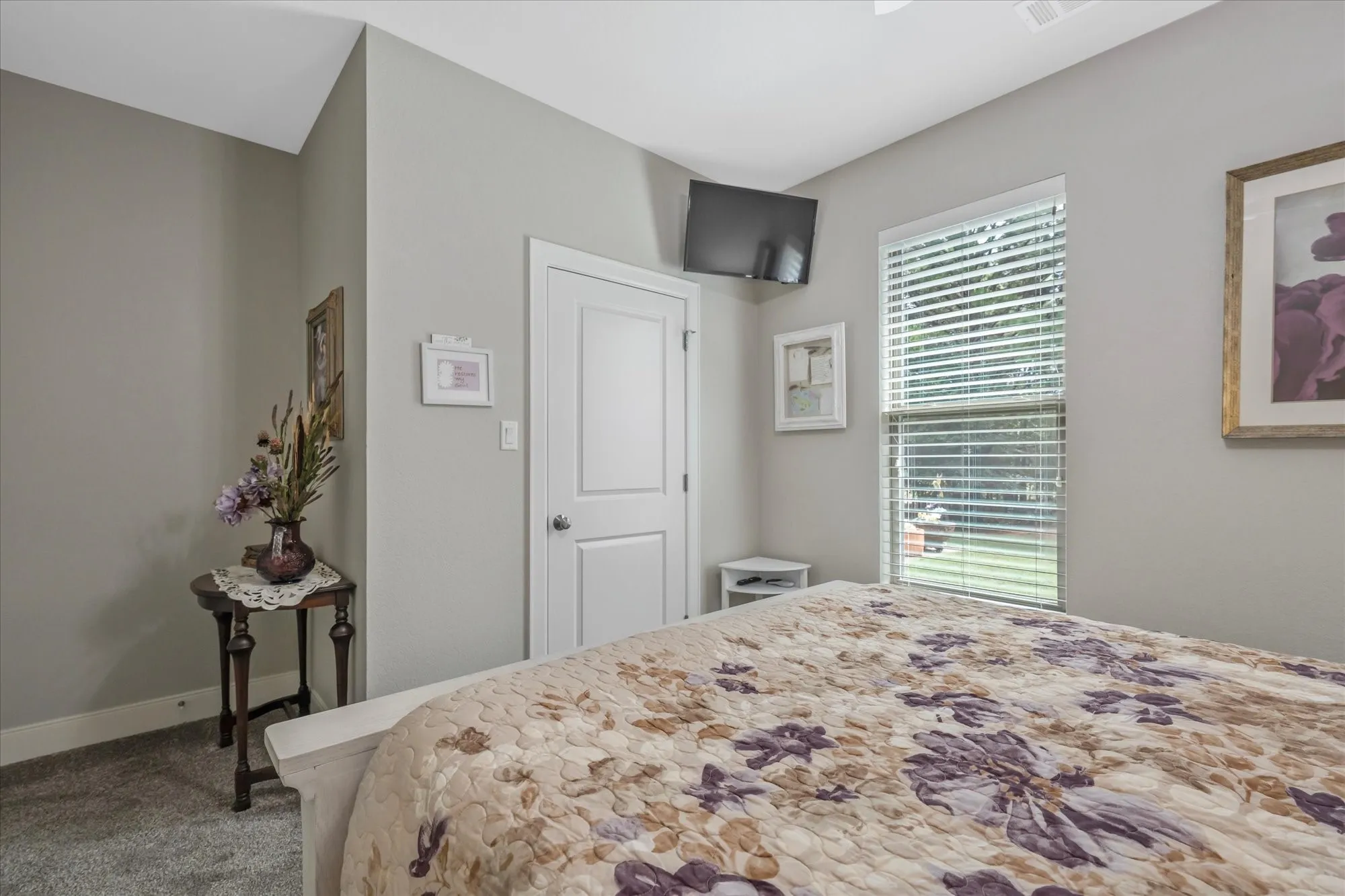 Neutral wall tones, white trim, and a window with horizontal blinds