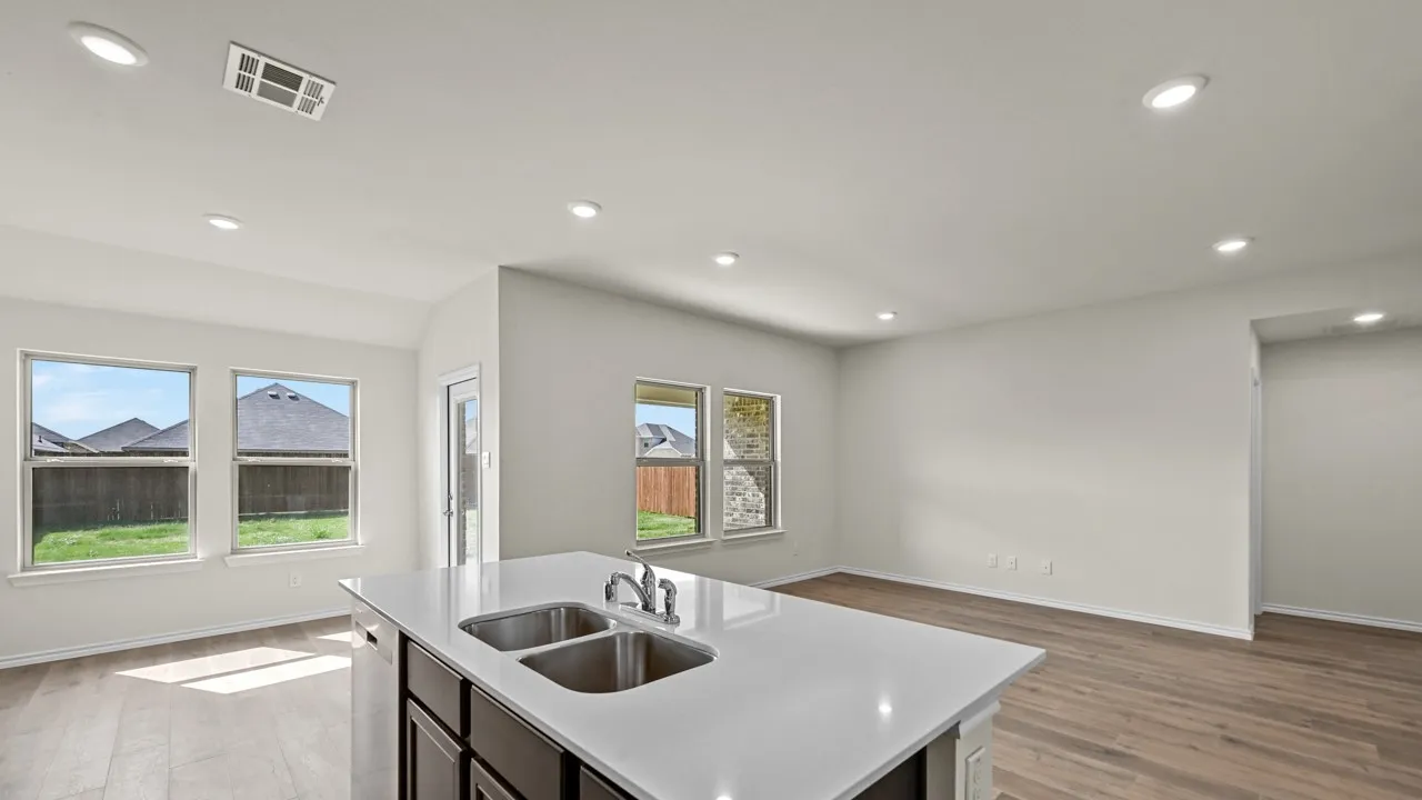 Kitchen island with dual stainless steel sinks and white countertop