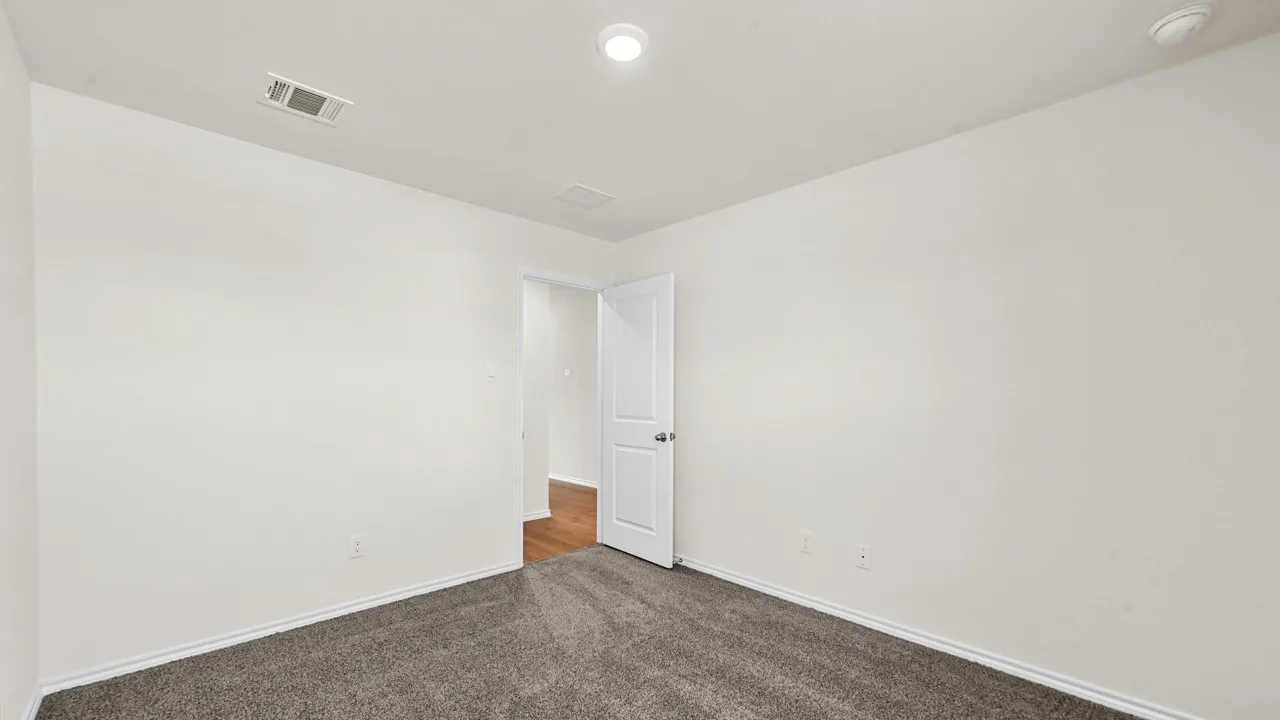 Neutral wall paint, recessed lighting, and grey carpet flooring