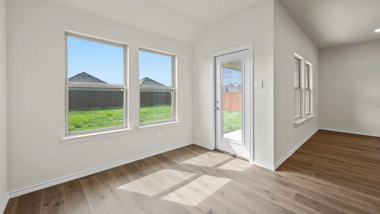 Wood-finish flooring, white walls, and multiple windows