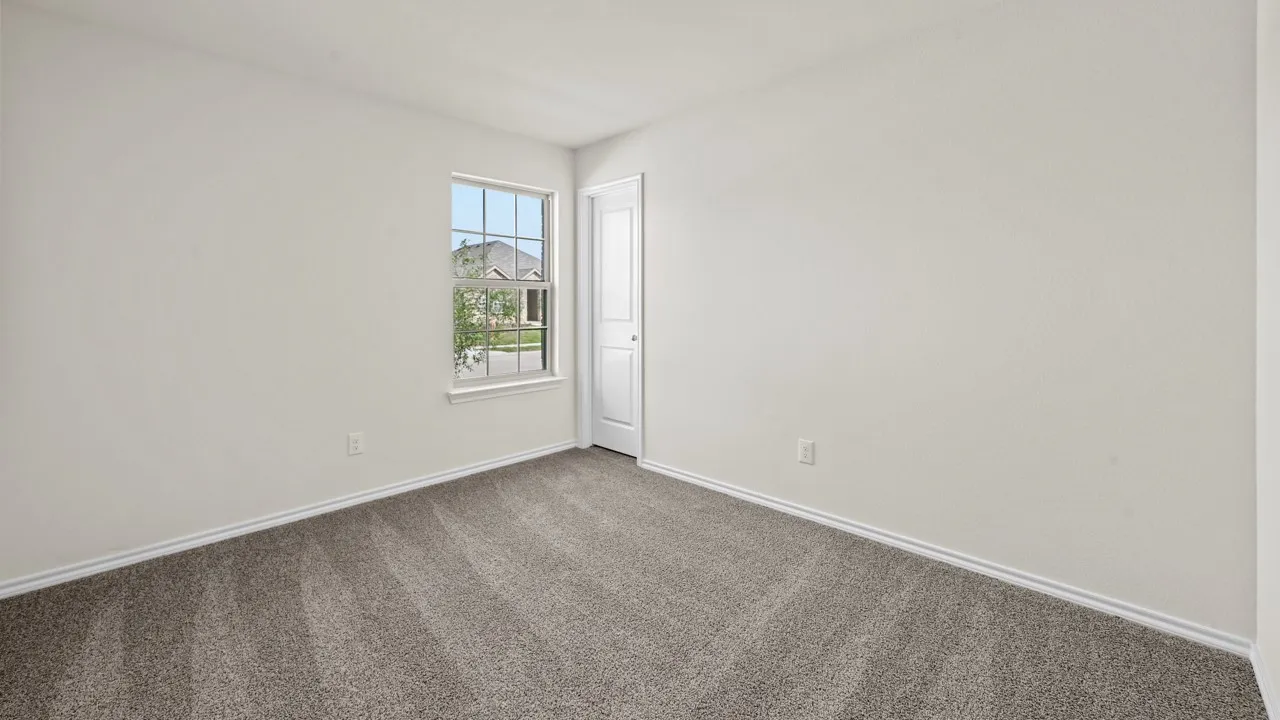 Neutral-toned walls complement plush grey carpeting
