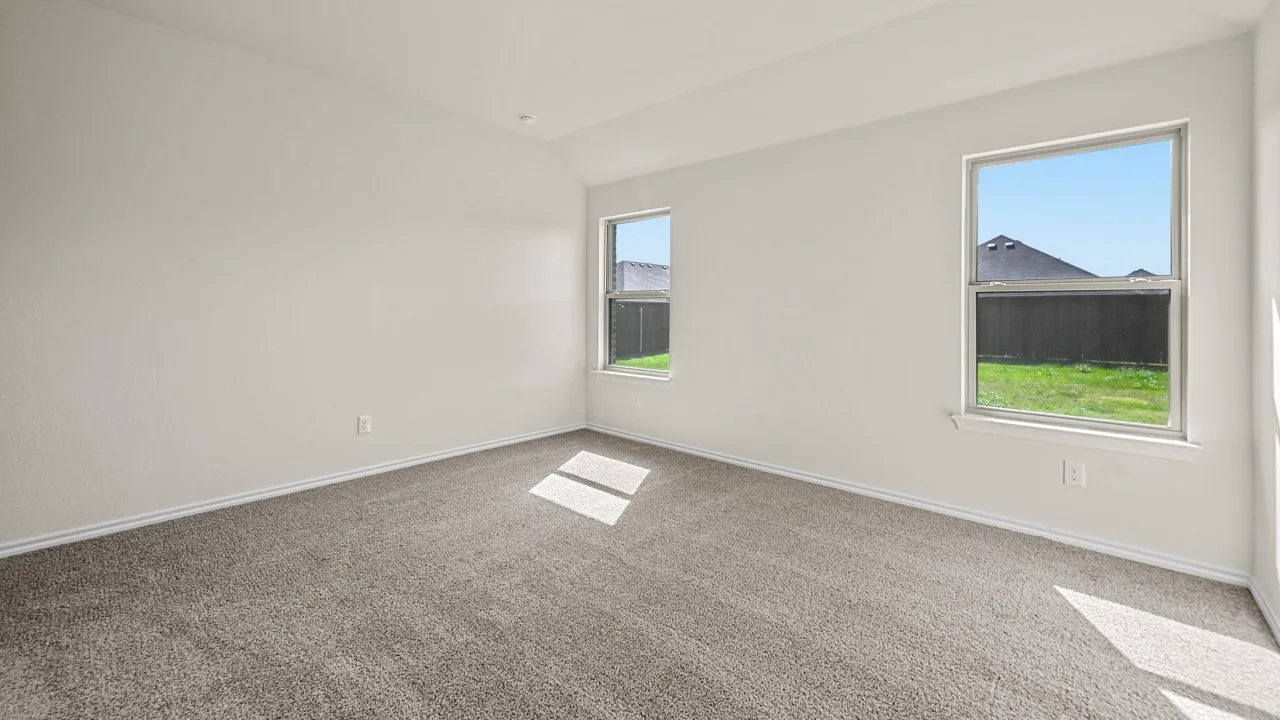 Neutral wall paint, carpet flooring, multiple windows, and a recessed ceiling light