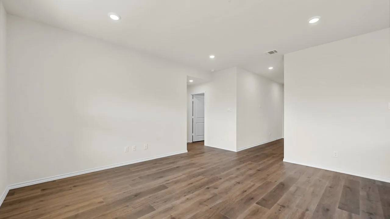 Recessed lighting, wood-finish flooring, white painted walls, and white trim