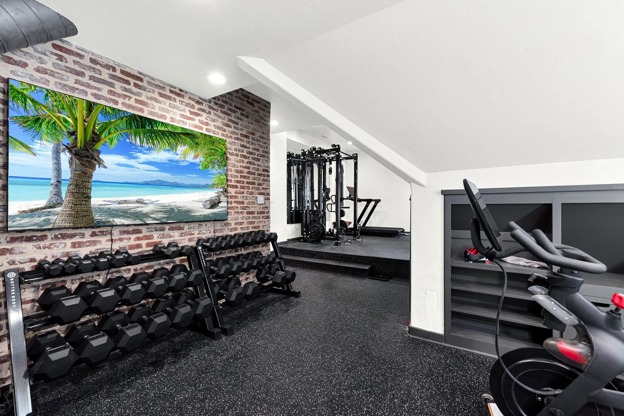 Exposed brick accenting brings industrial character to the space, beautifully juxtaposed against clean white ceiling angles. Picture powering through an afternoon training session, completely energized within your private home sanctuary.