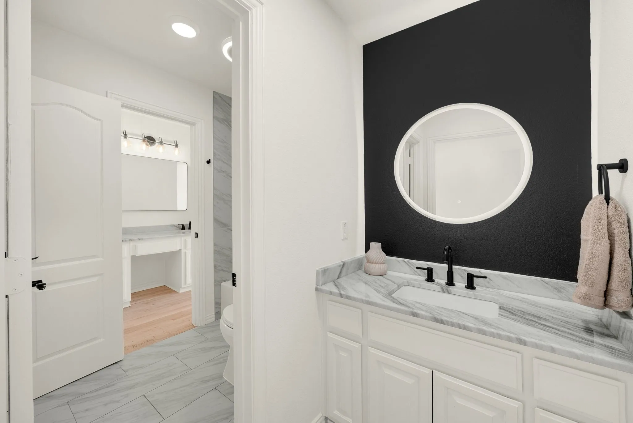 White vanity with a stone countertop and integrated sink