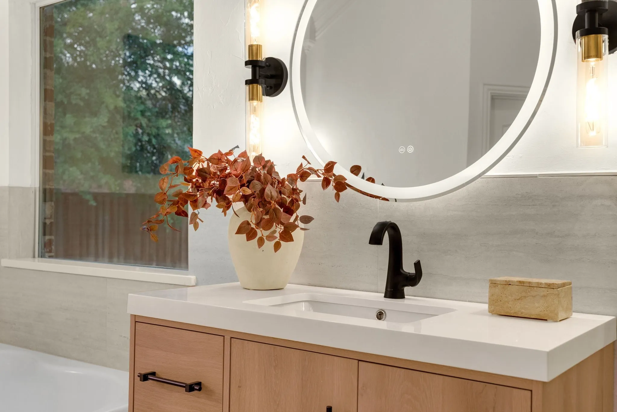 Modern bathroom vanity featuring warm wood-finish cabinetry with multiple storage drawers, a white quartz countertop, and a rectangular vessel sink