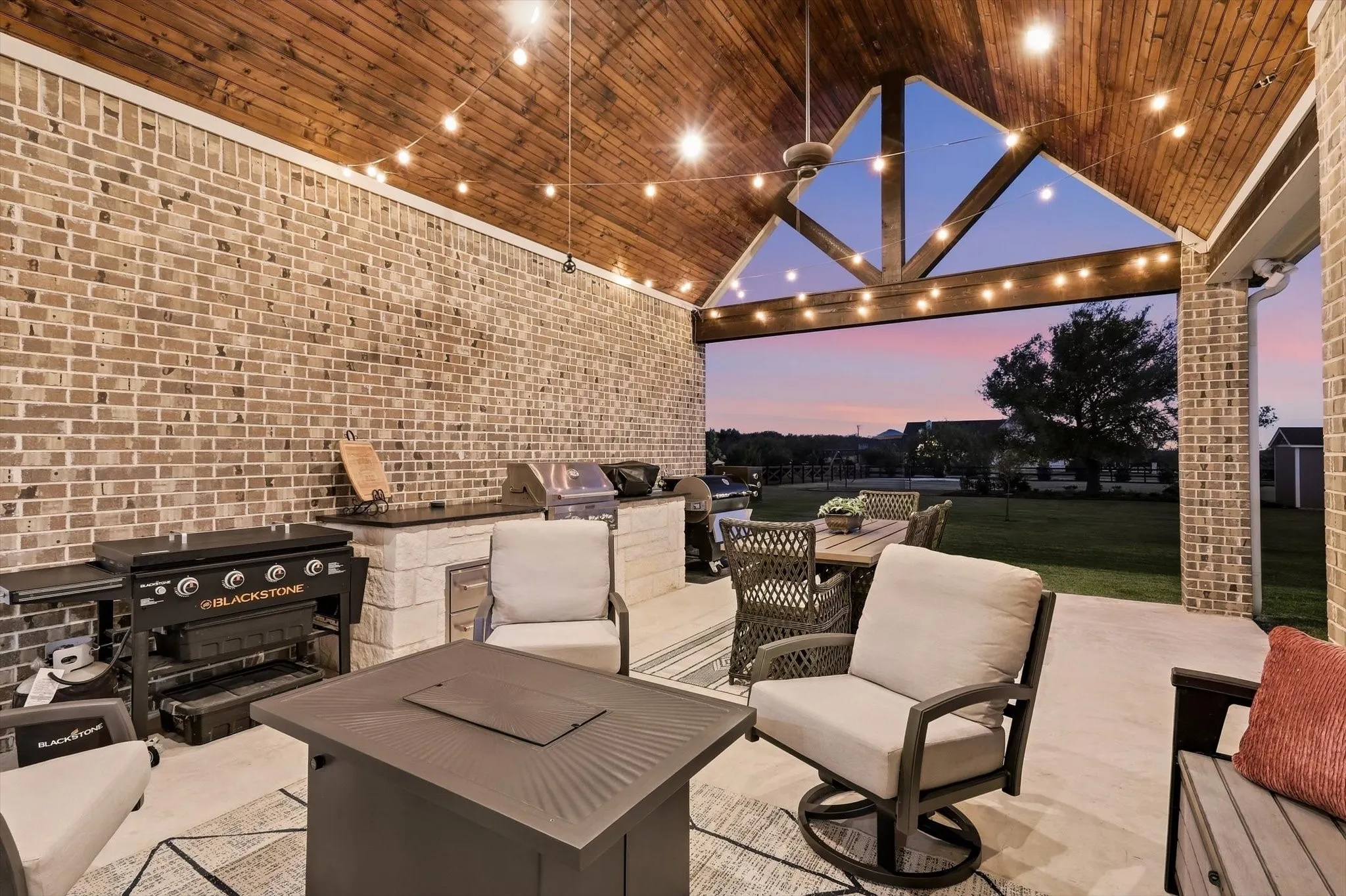 Large covered patio with tongue and groove pine cathedral ceiling has built-in grill, storage, ice chest