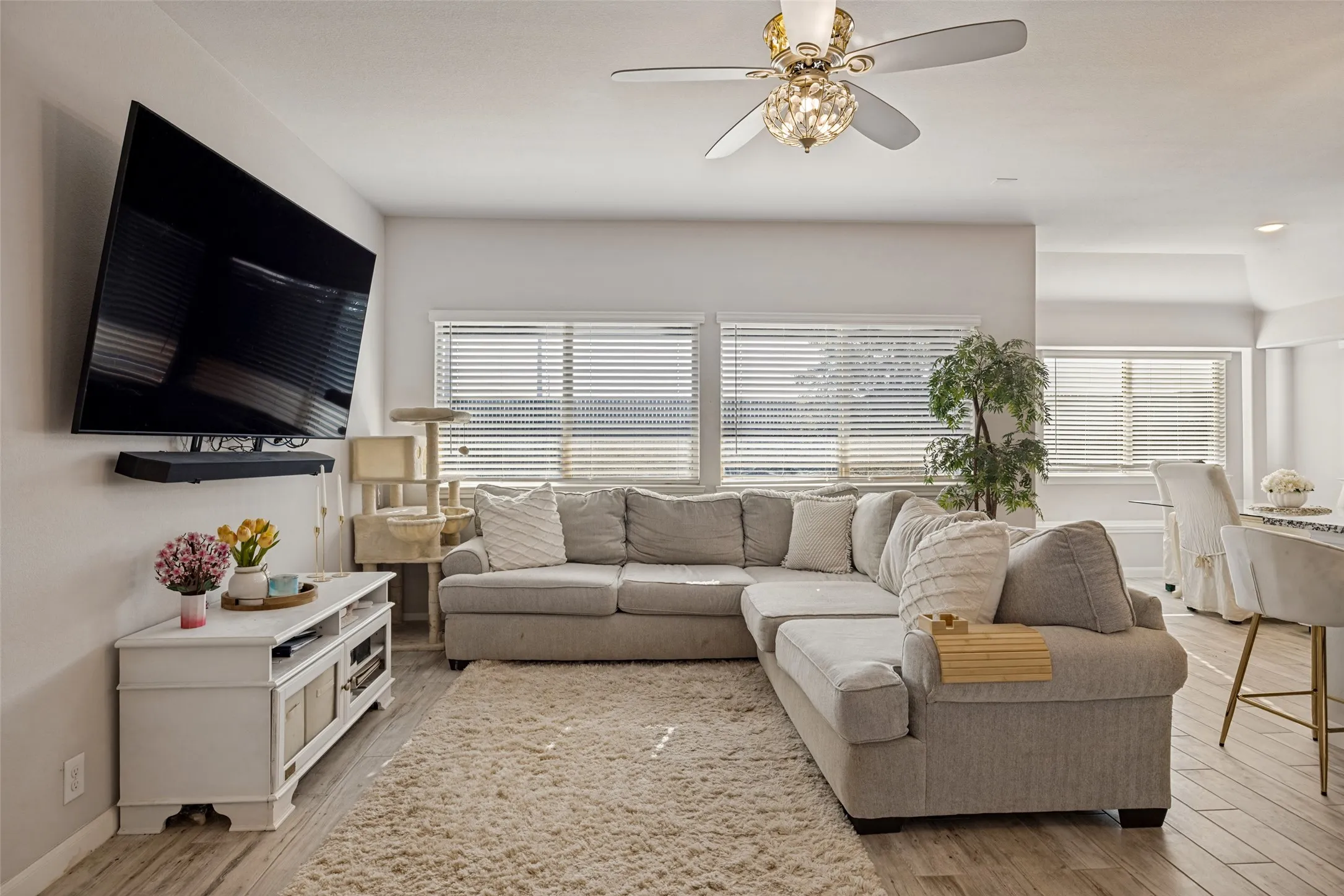 Wood-finish flooring throughout, complemented by a ceiling fan with integrated lighting