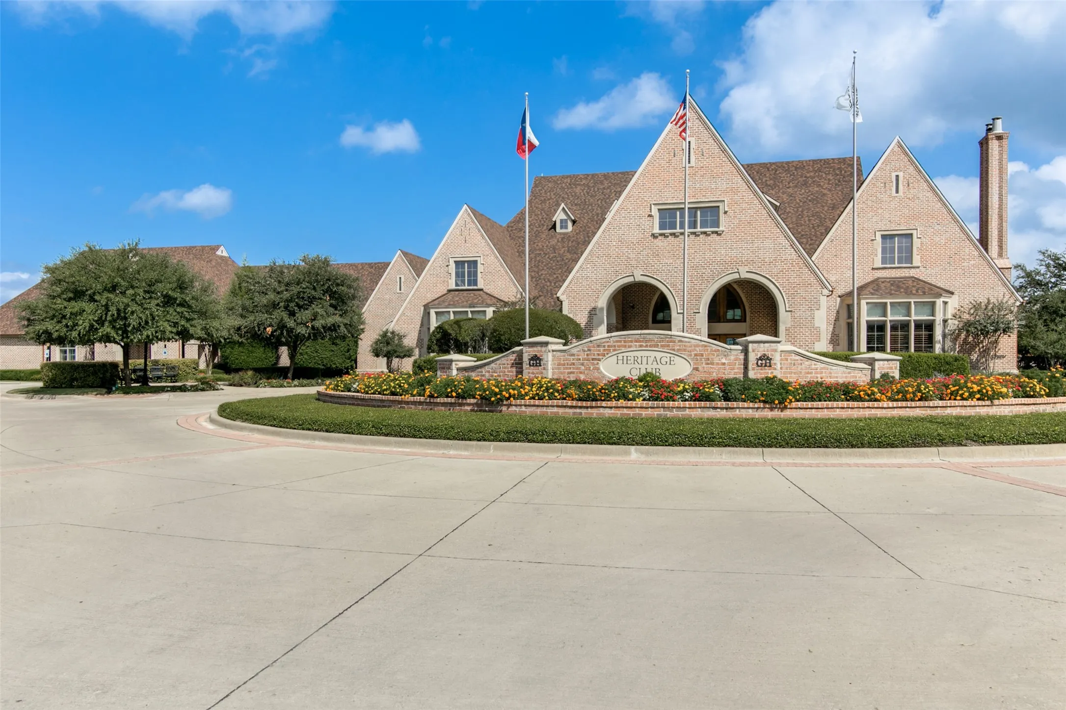 Brick exterior with multiple gables, arched entryways, and a prominent signage wall