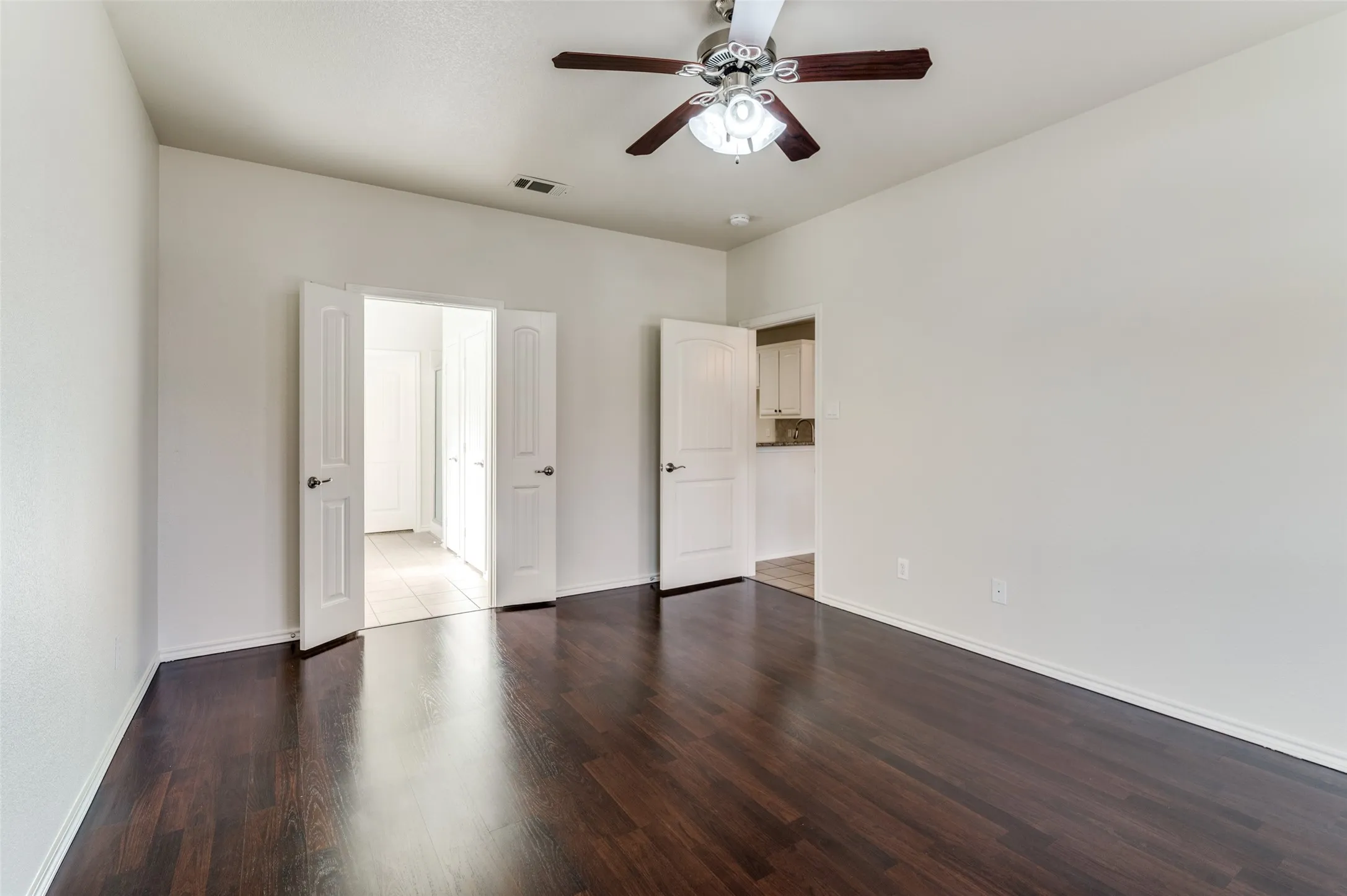 Unfurnished bedroom featuring wood finished floors and a ceiling fan
