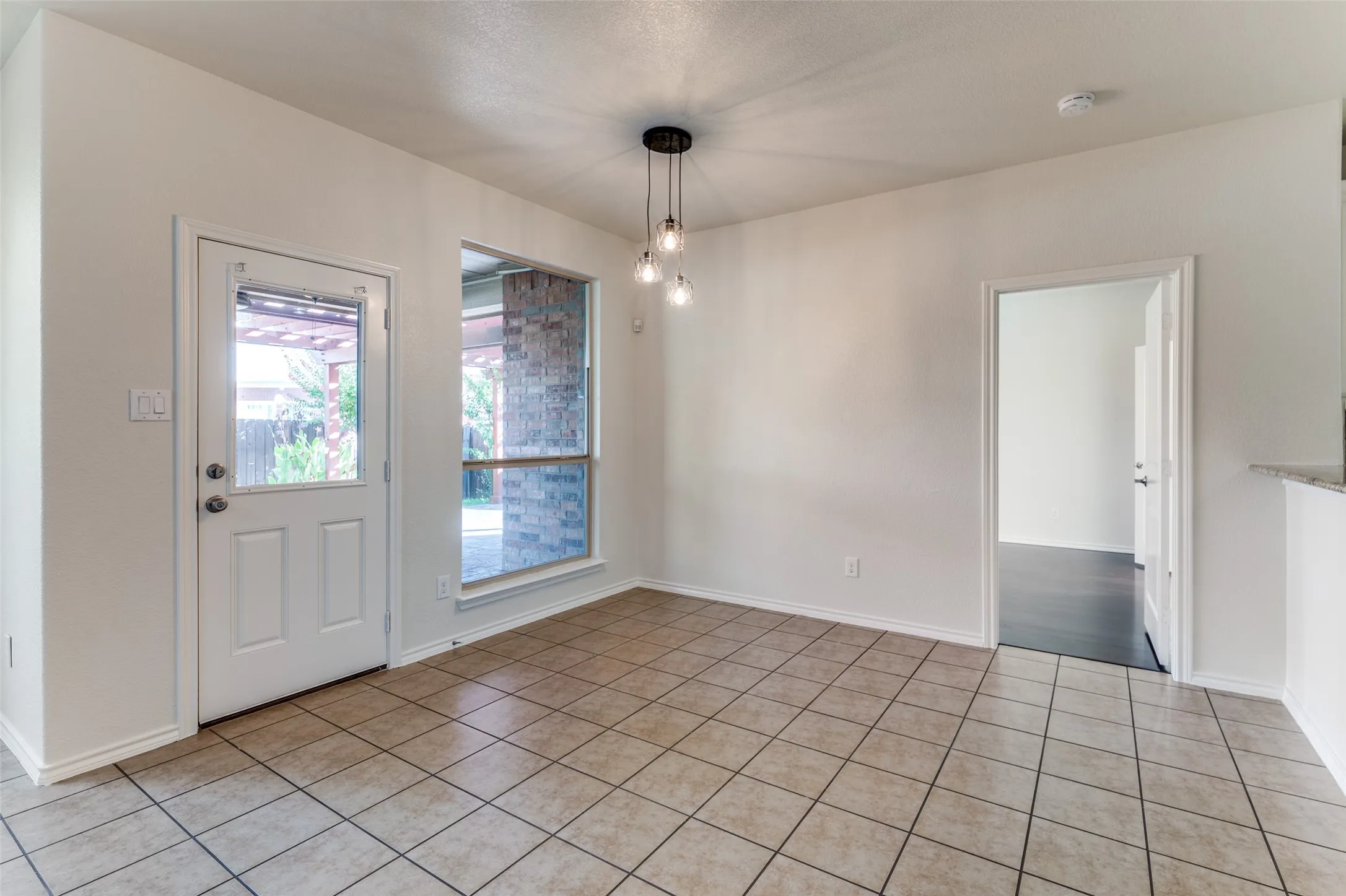 Unfurnished dining area featuring baseboards and light tile patterned flooring