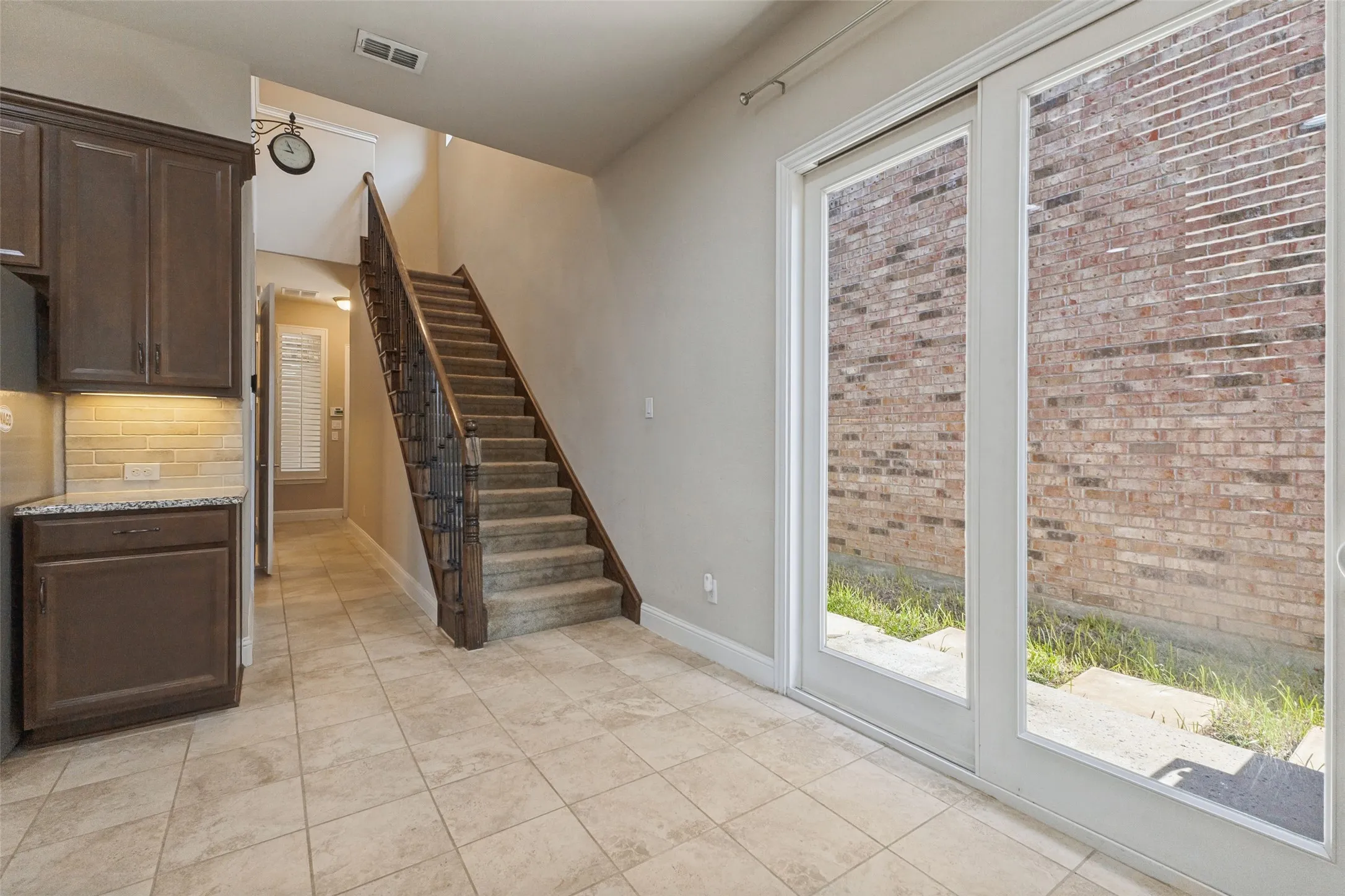 Dining area in kitchen with sliding doors going out to side yard