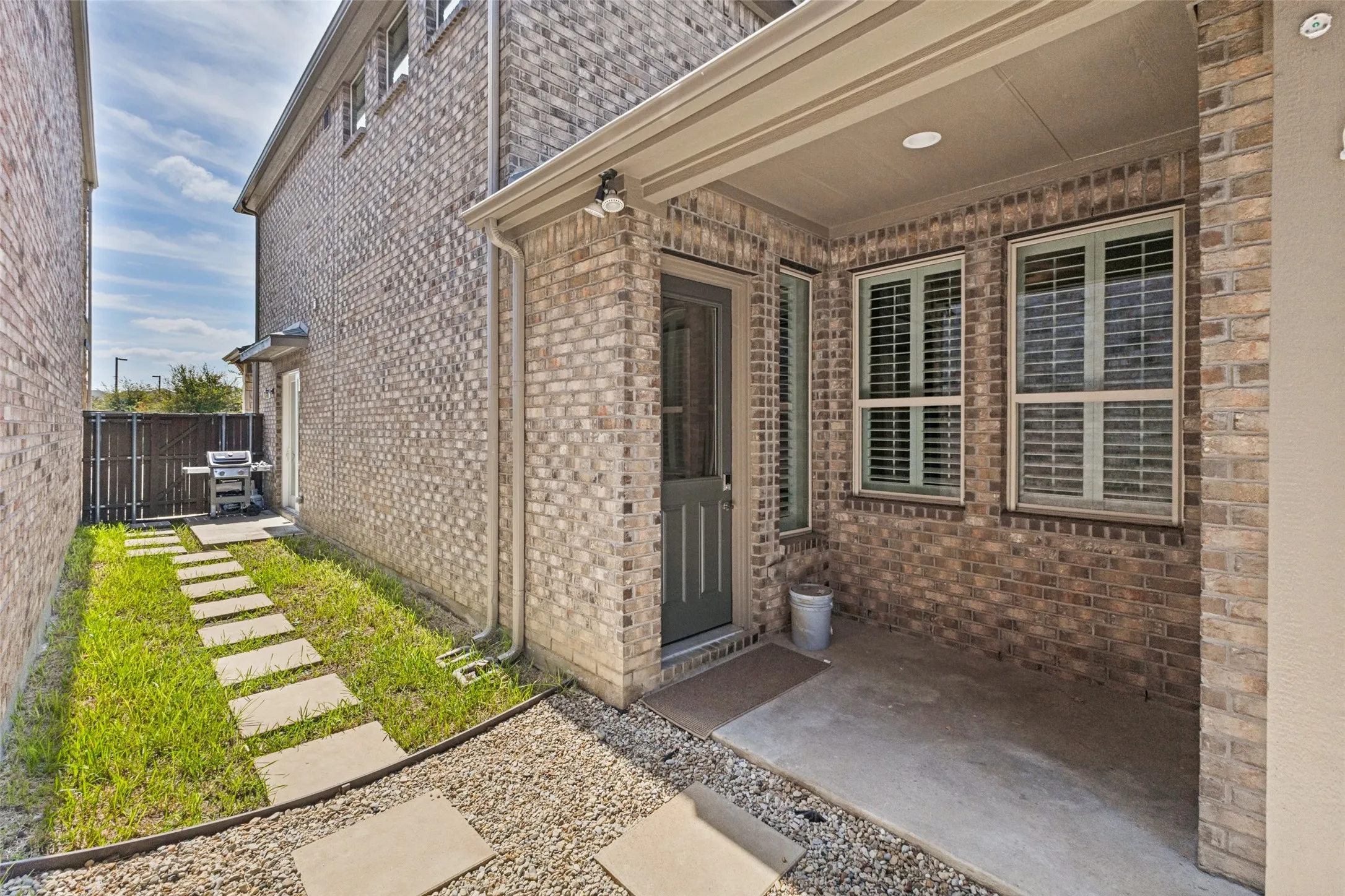 Covered area from garage to back entry of home.