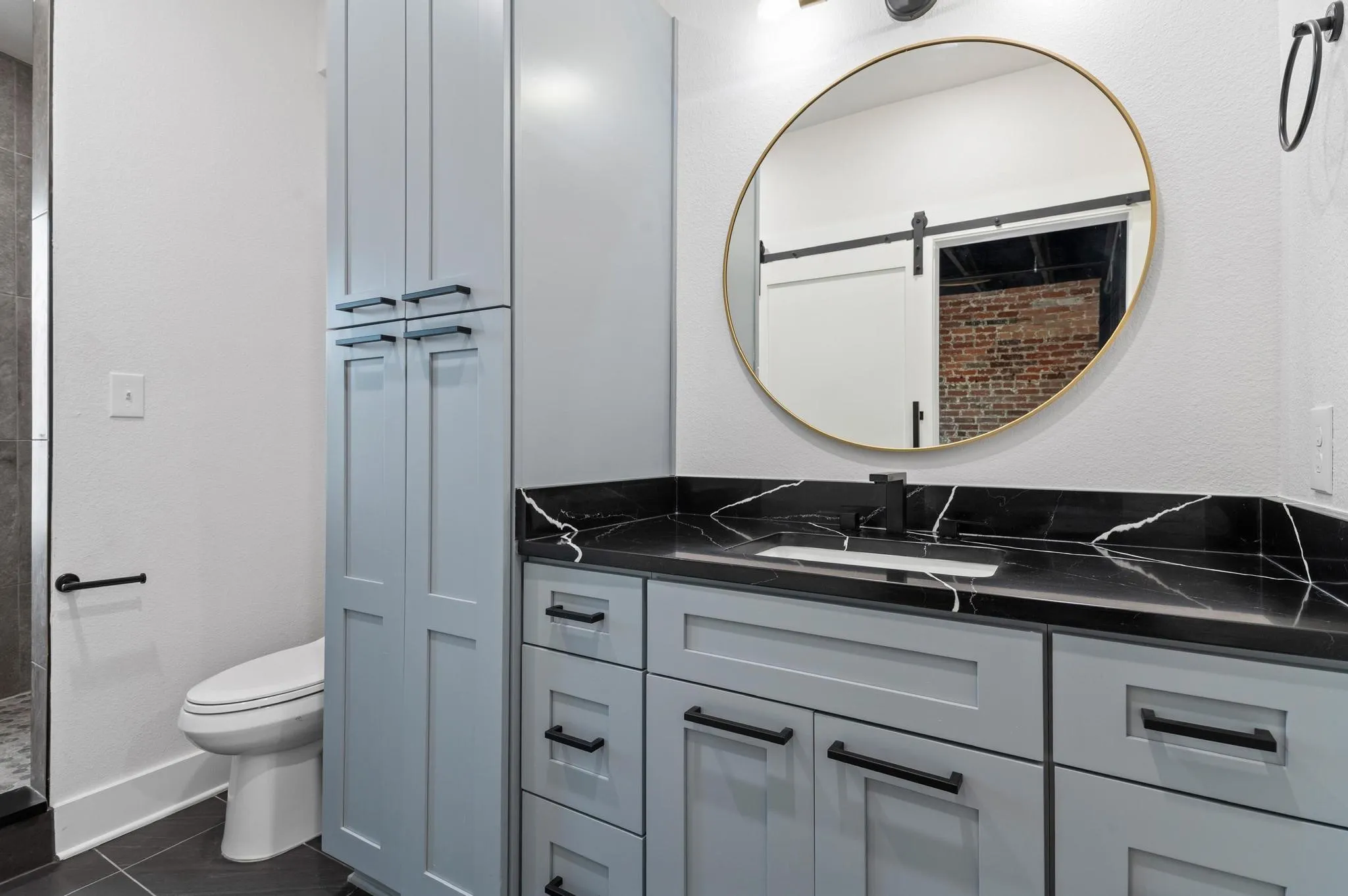 Light blue shaker-style cabinetry with matte black hardware