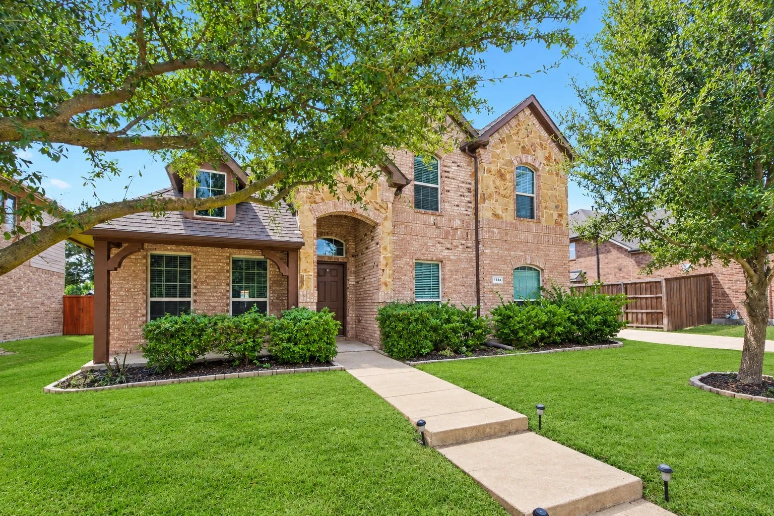 Brick and stone exterior with arched entry