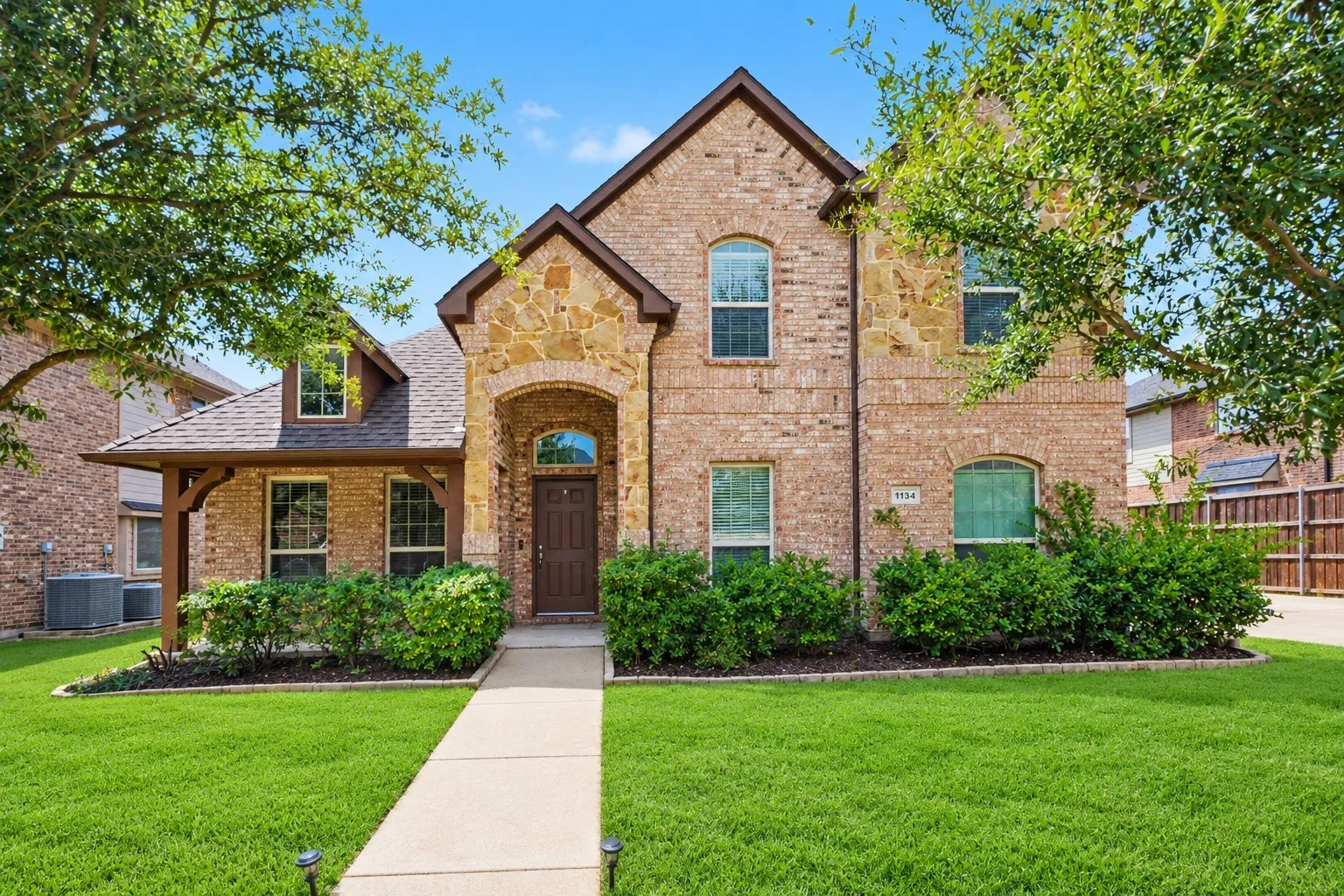 Brick and stone facade with arched entry