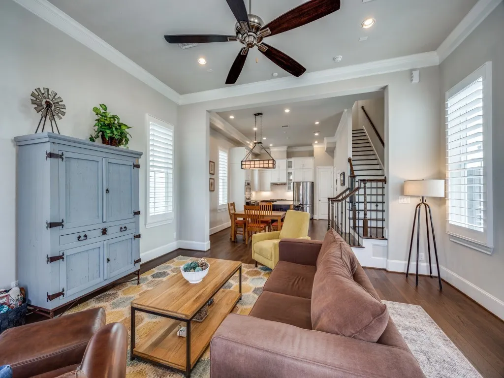 Recessed lighting, crown molding, wood-finish flooring, plantation shutters, and a ceiling fan