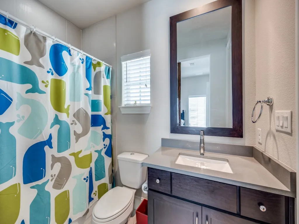 Dark wood-finish vanity with an integrated sink, polished chrome faucet, and framed mirror