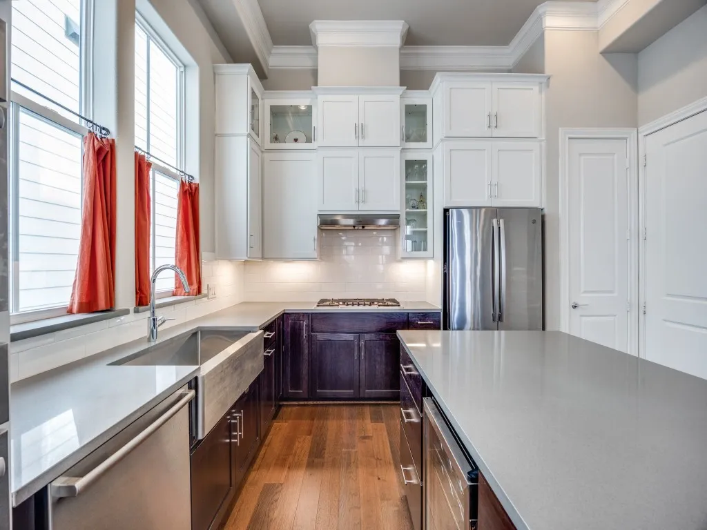Contemporary kitchen featuring white shaker upper cabinetry and dark wood-finish lower cabinetry