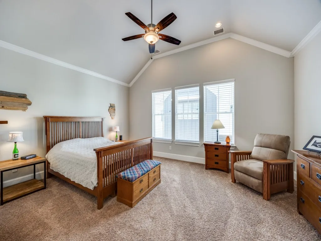 Vaulted ceiling with a ceiling fan, three windows with blinds, recessed lighting, and carpet flooring