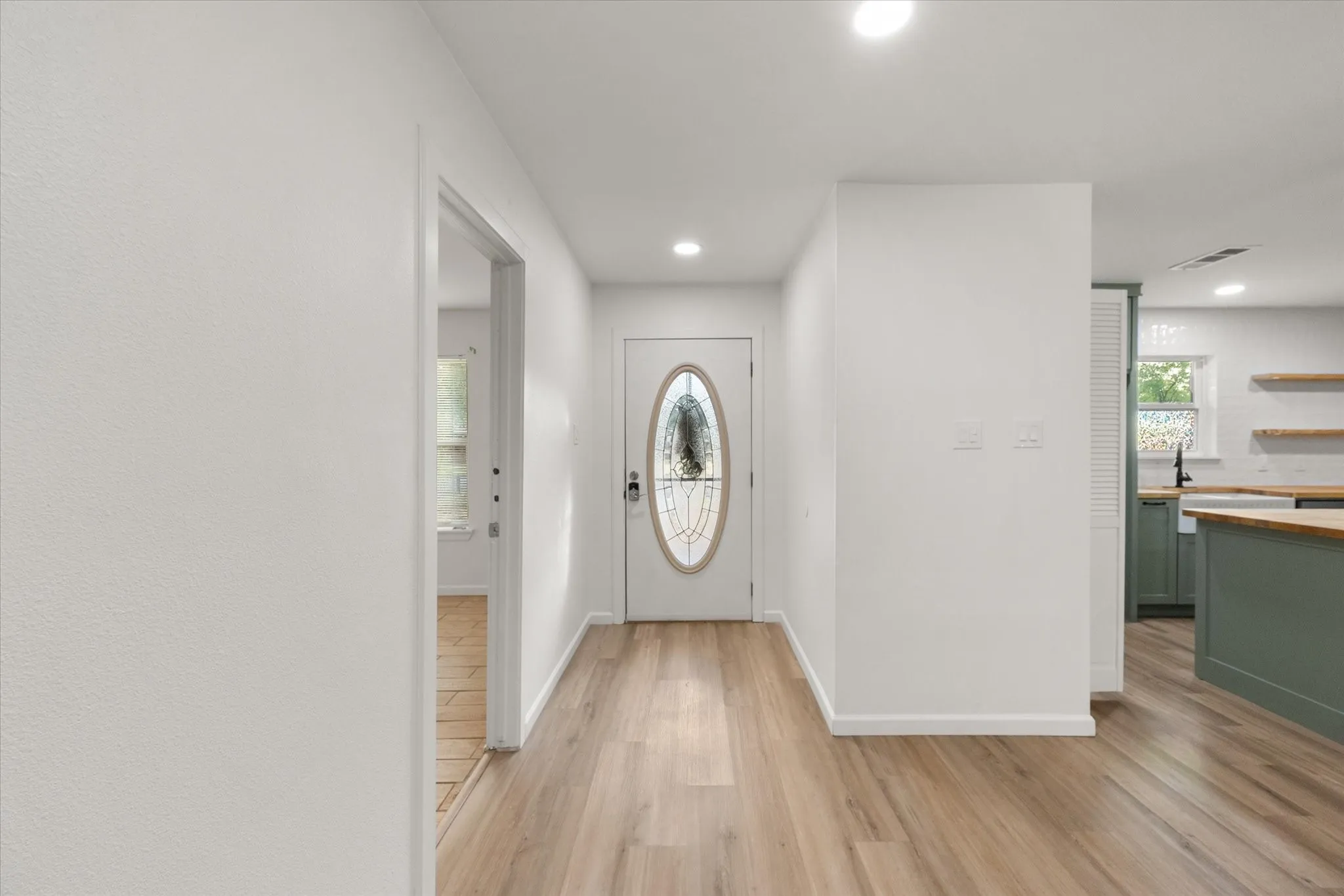 Front entry door with smart lock and glass detail.