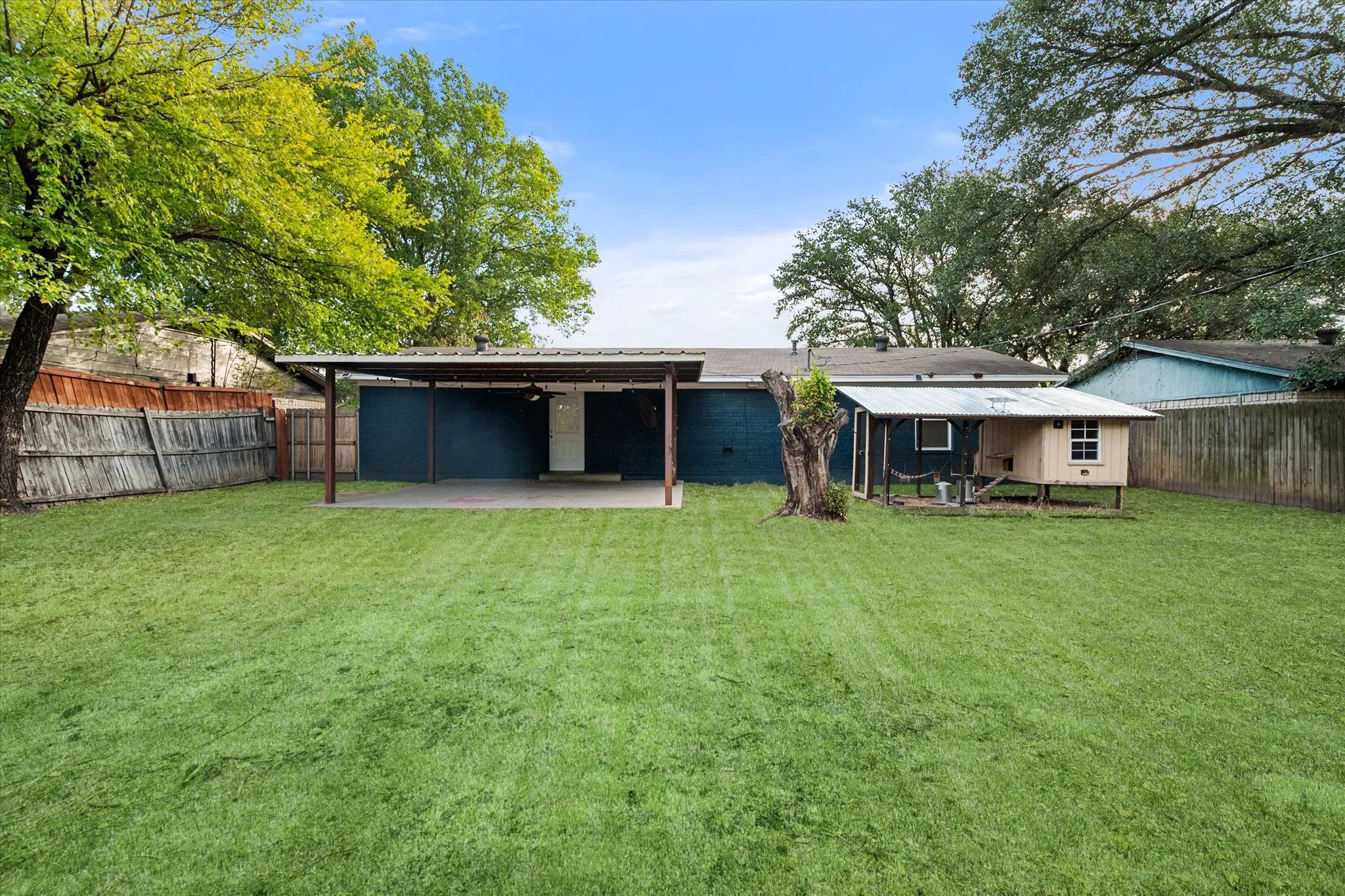 Spacious backyard with a covered patio.