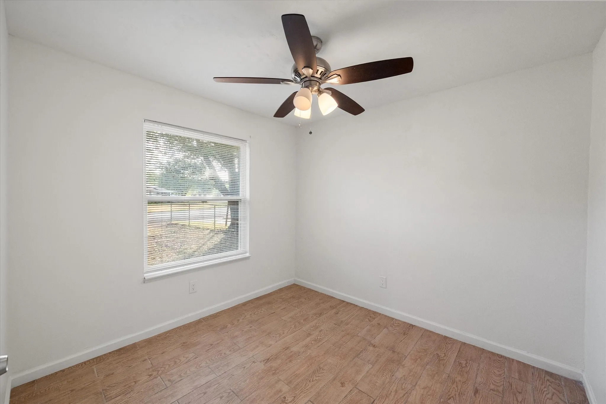 Secondary bedroom featuring wood like ceramic tile flooring.
