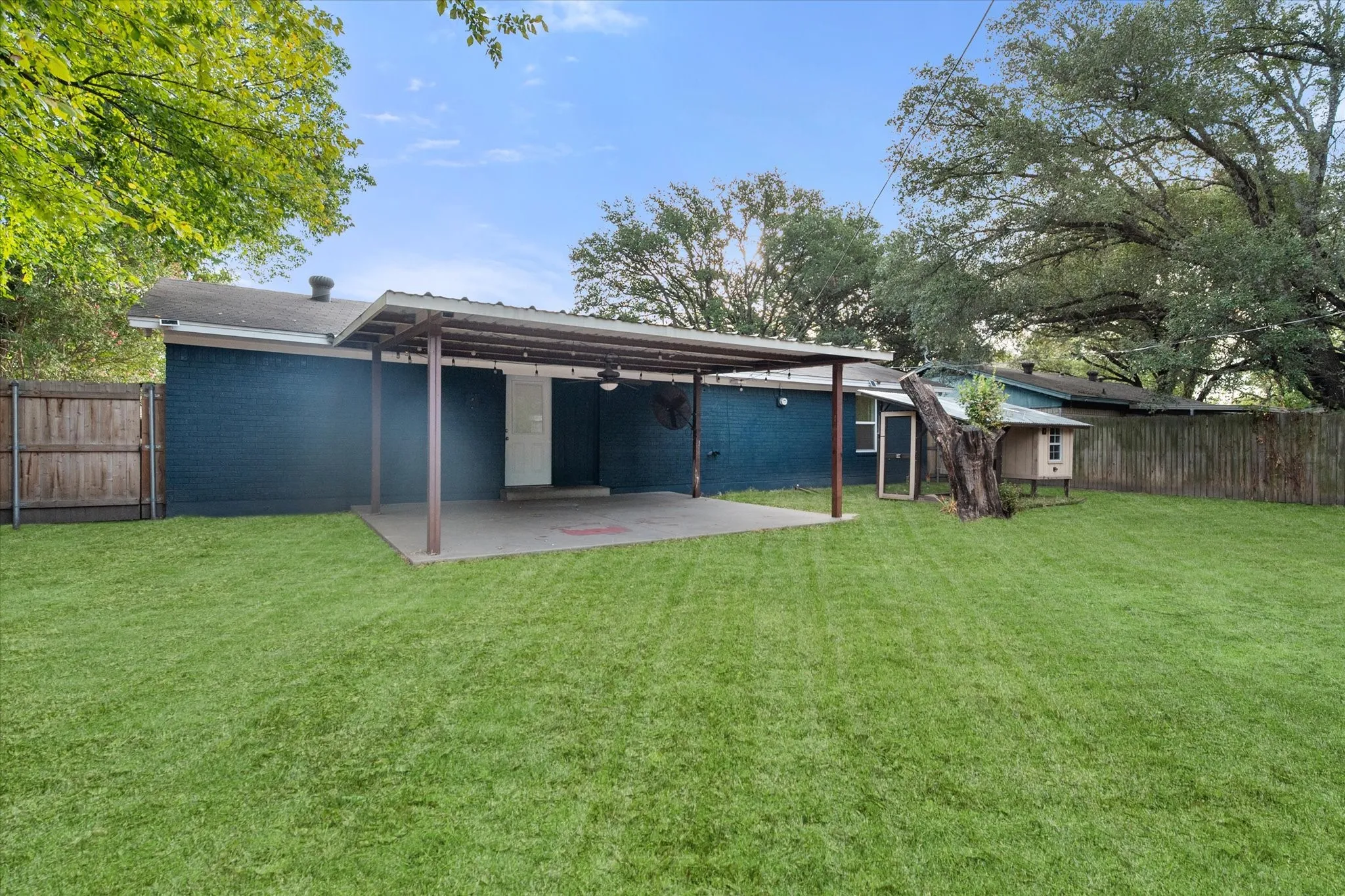 Spacious backyard with a covered patio.