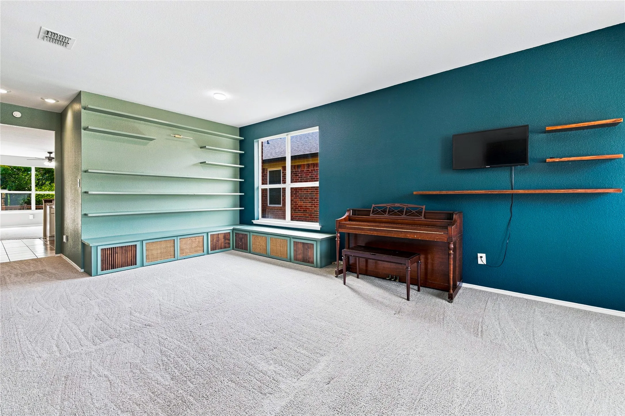 Built-in shelving with integrated cabinetry, window with a built-in bench, recessed lighting, and wall-mounted wooden shelves