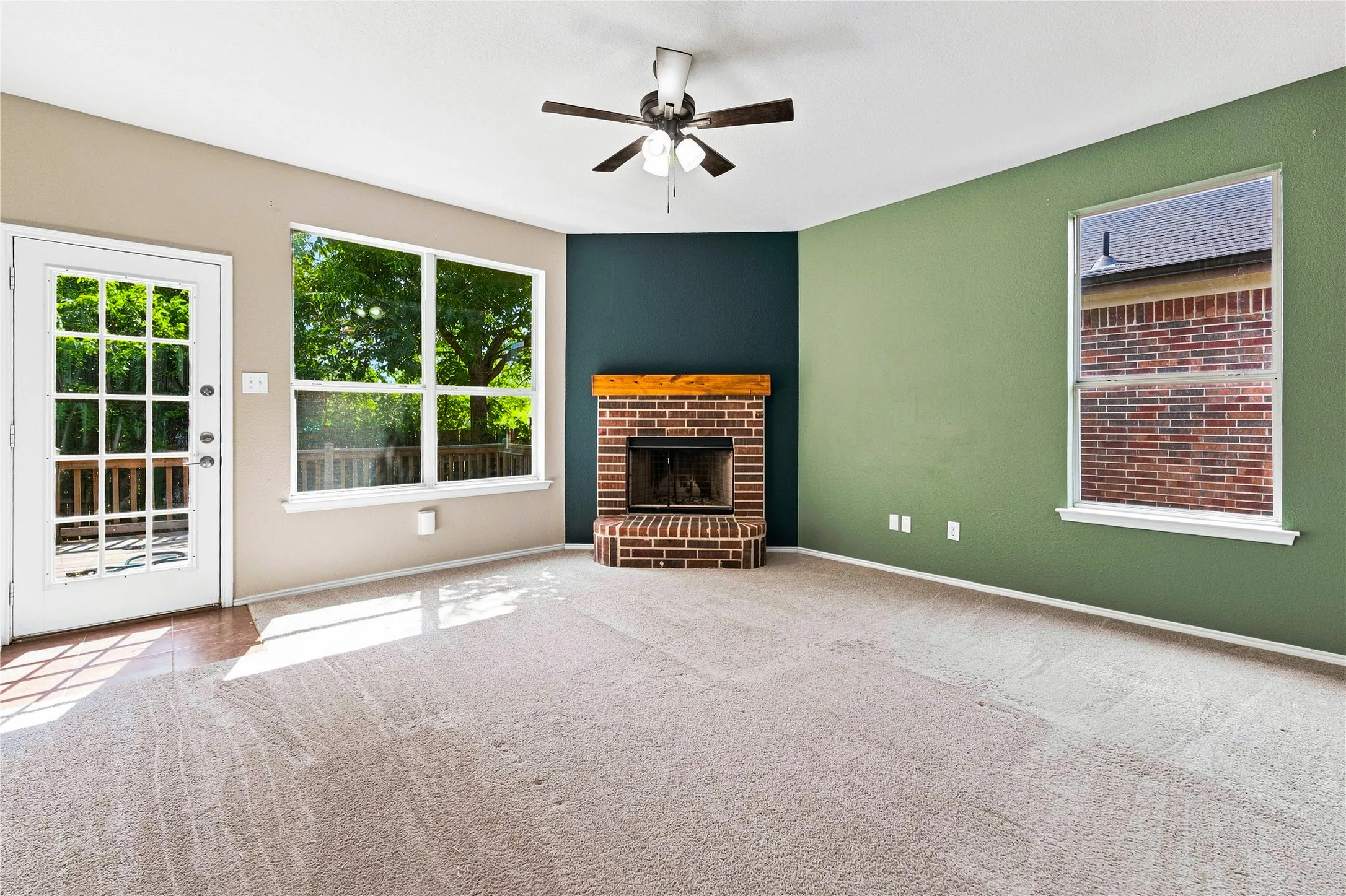 Corner brick fireplace with wood mantel