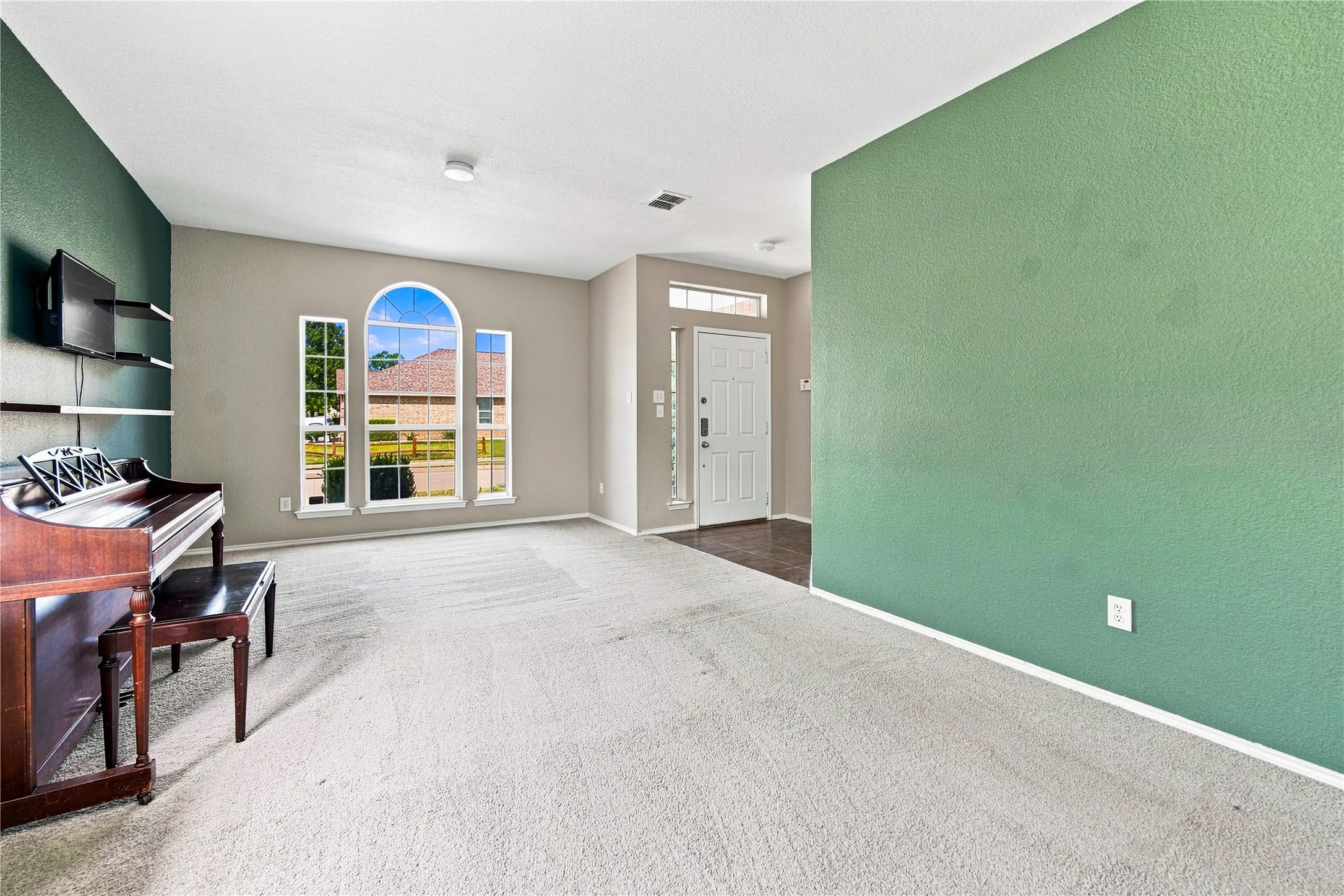 Carpeted flooring complemented by light-toned wall paint and an accent wall