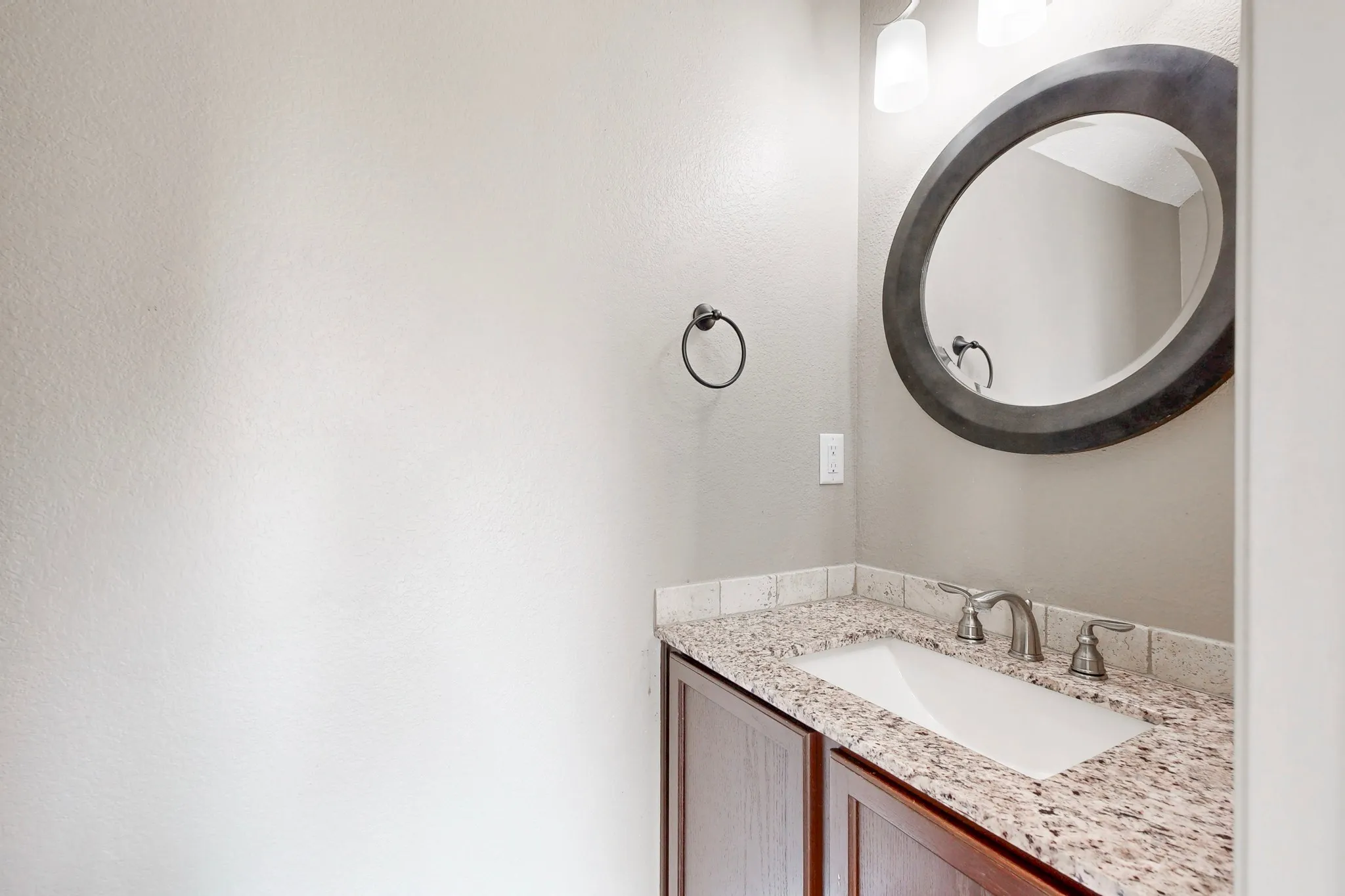 Guest bathroom with a granite countertop, and upgraded brushed nickel fixtures.