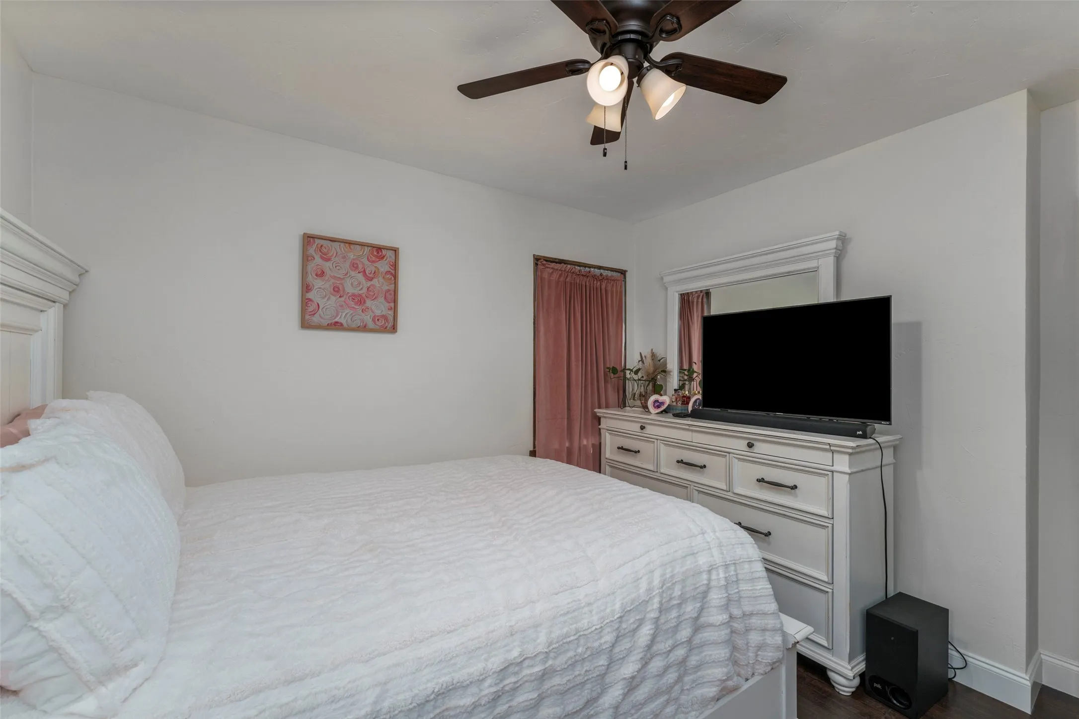White walls with dark wood-finish flooring