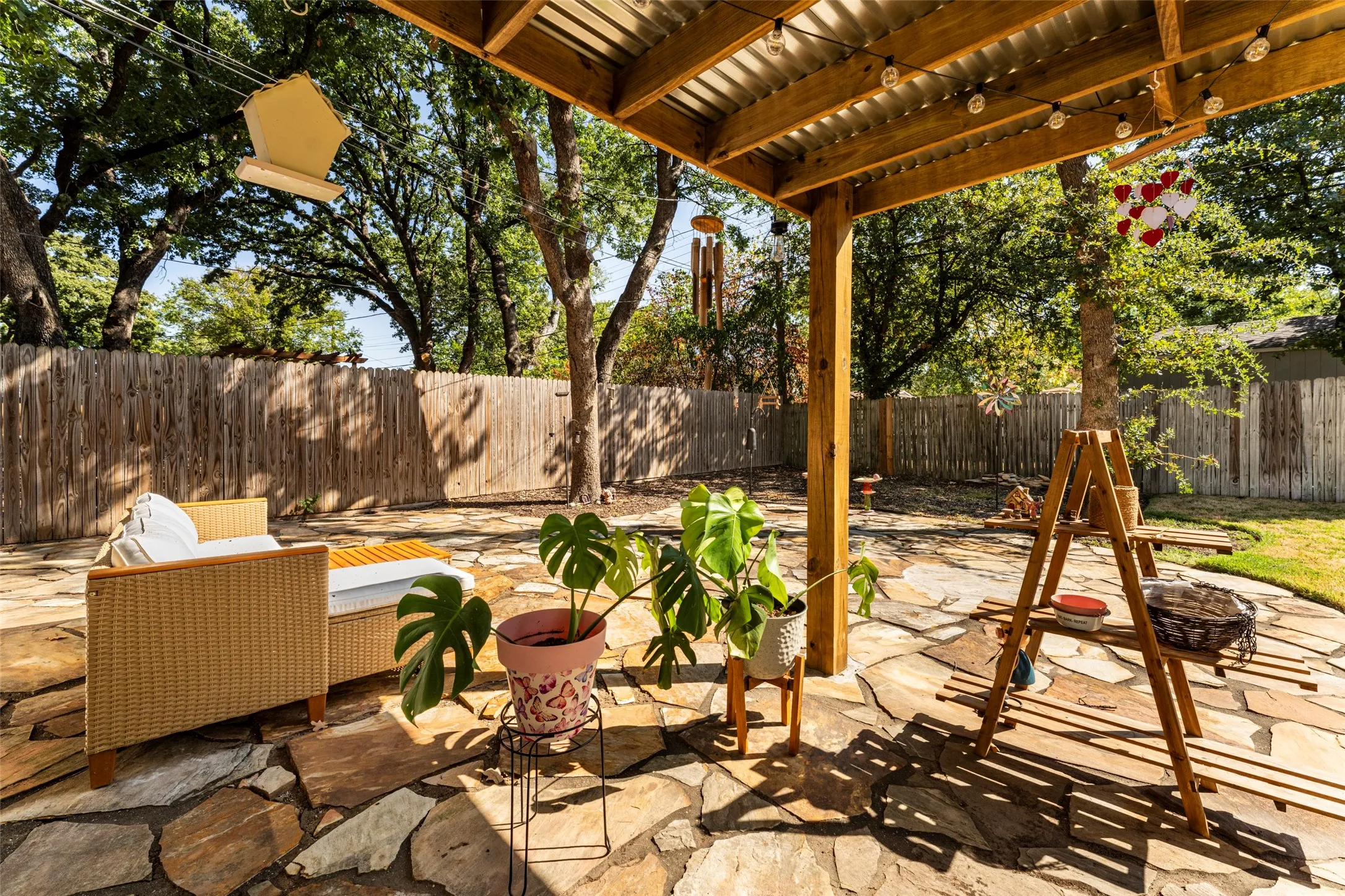 Covered patio with a wood beam structure and corrugated metal roof