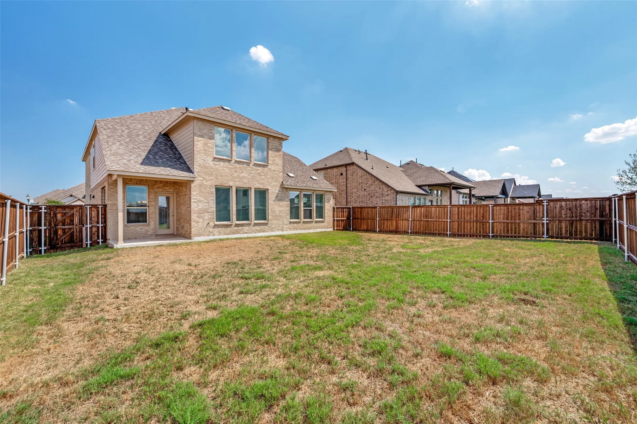 Expansive backyard featuring a full perimeter wood privacy fence