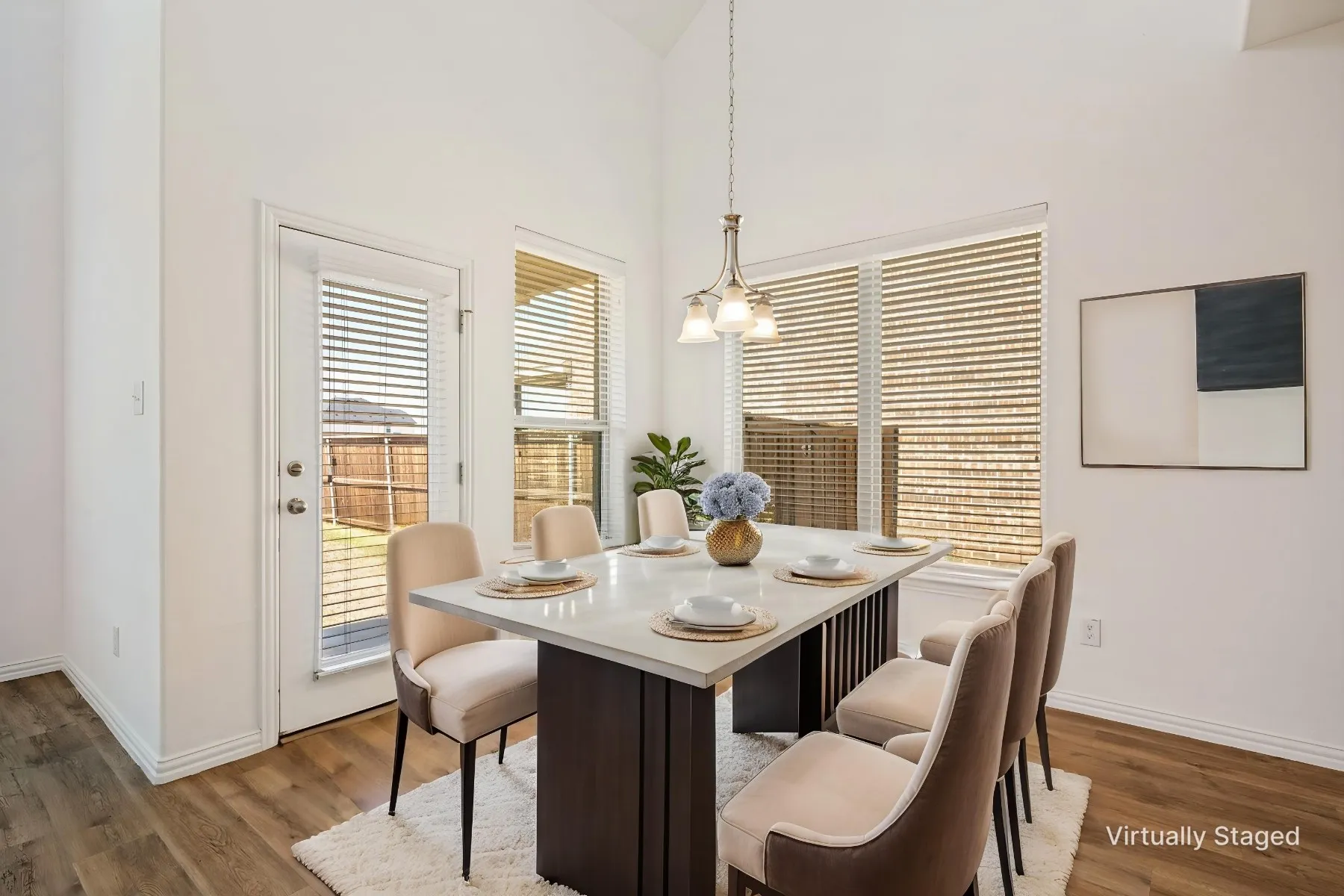 Vaulted ceiling, wood-finish flooring, white walls, and a glass-paneled exterior​​‌​​​​‌​​‌‌​‌‌​​​‌‌​‌​‌​‌​​​‌​​ door