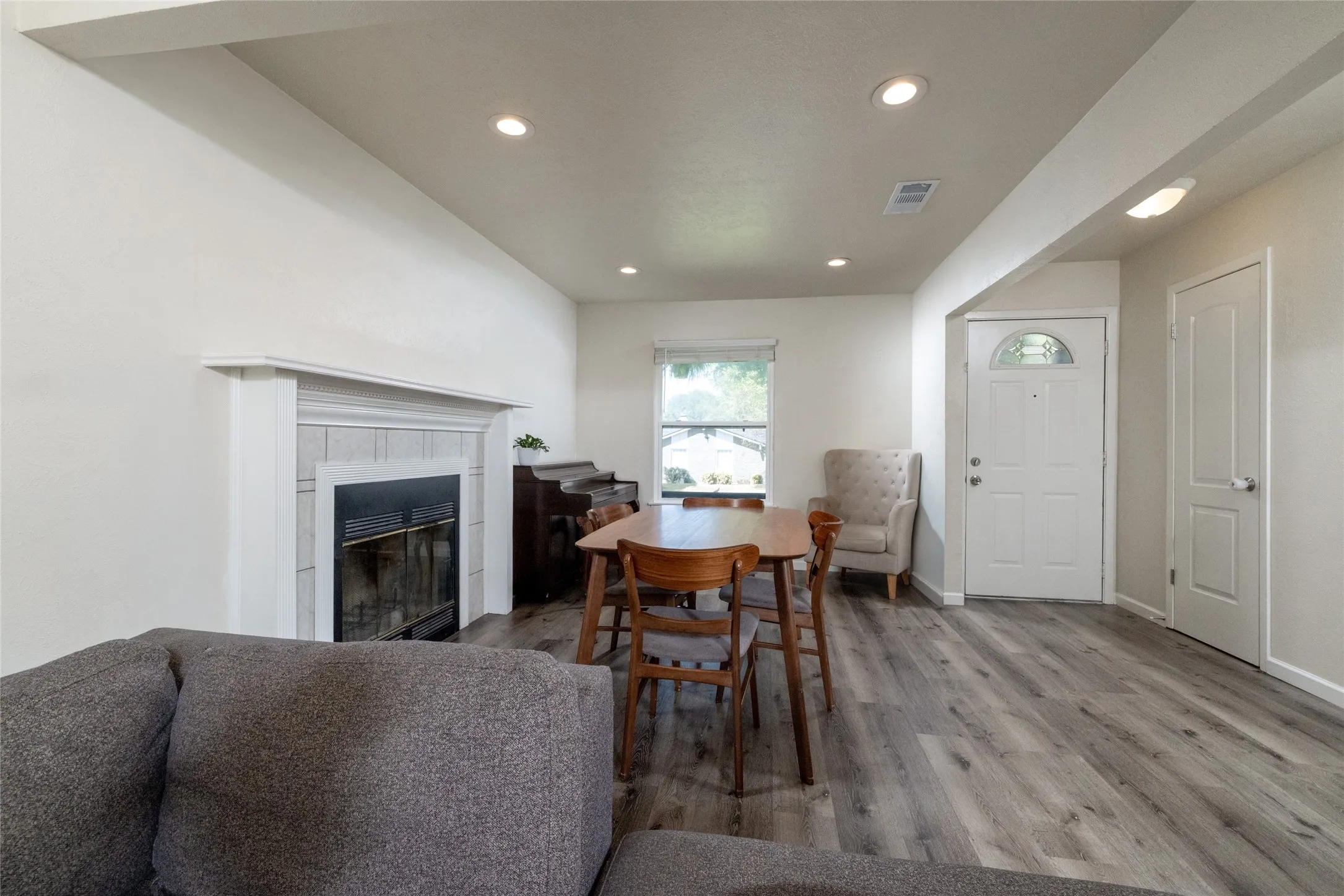 Wood-finish flooring throughout, recessed lighting, and a window with natural light