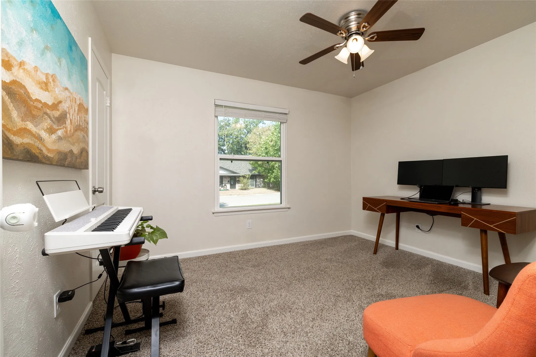 Recessed window with exterior views, ceiling fan with integrated lighting, and carpeted flooring
