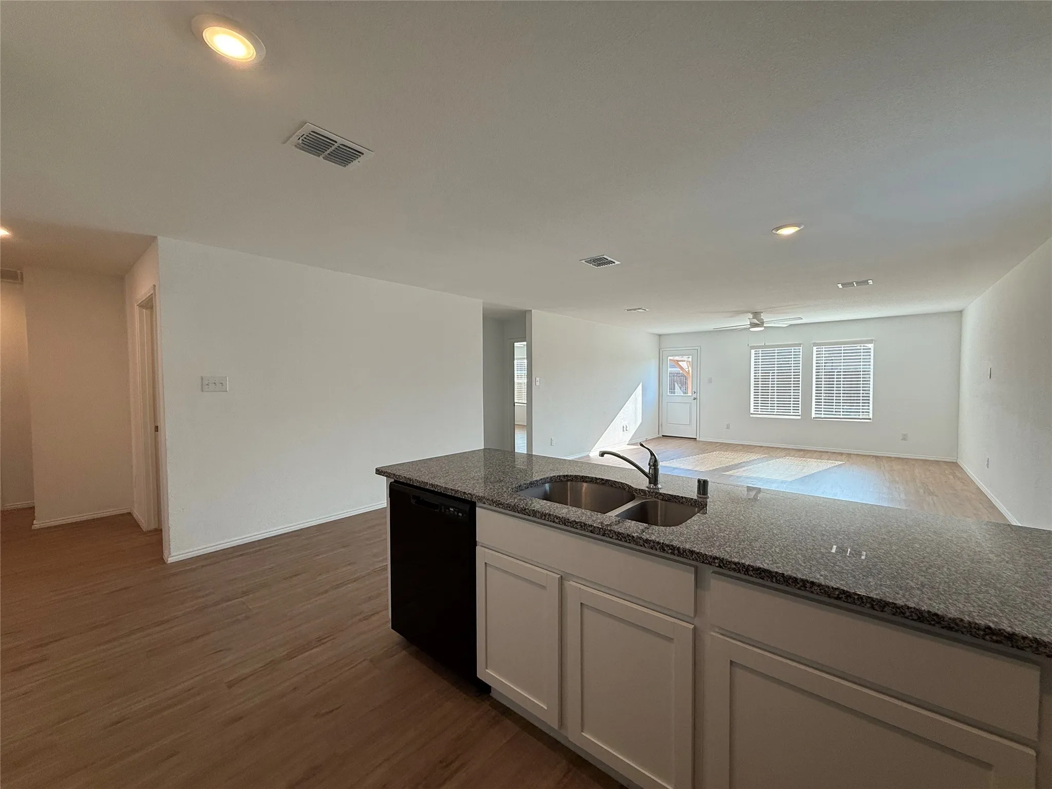 Kitchen island with a double basin sink and a dark-finish faucet