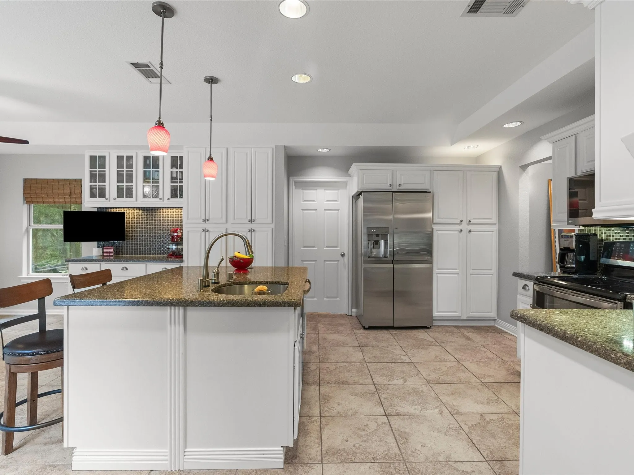 Kitchen featuring the island and built-in pantry.