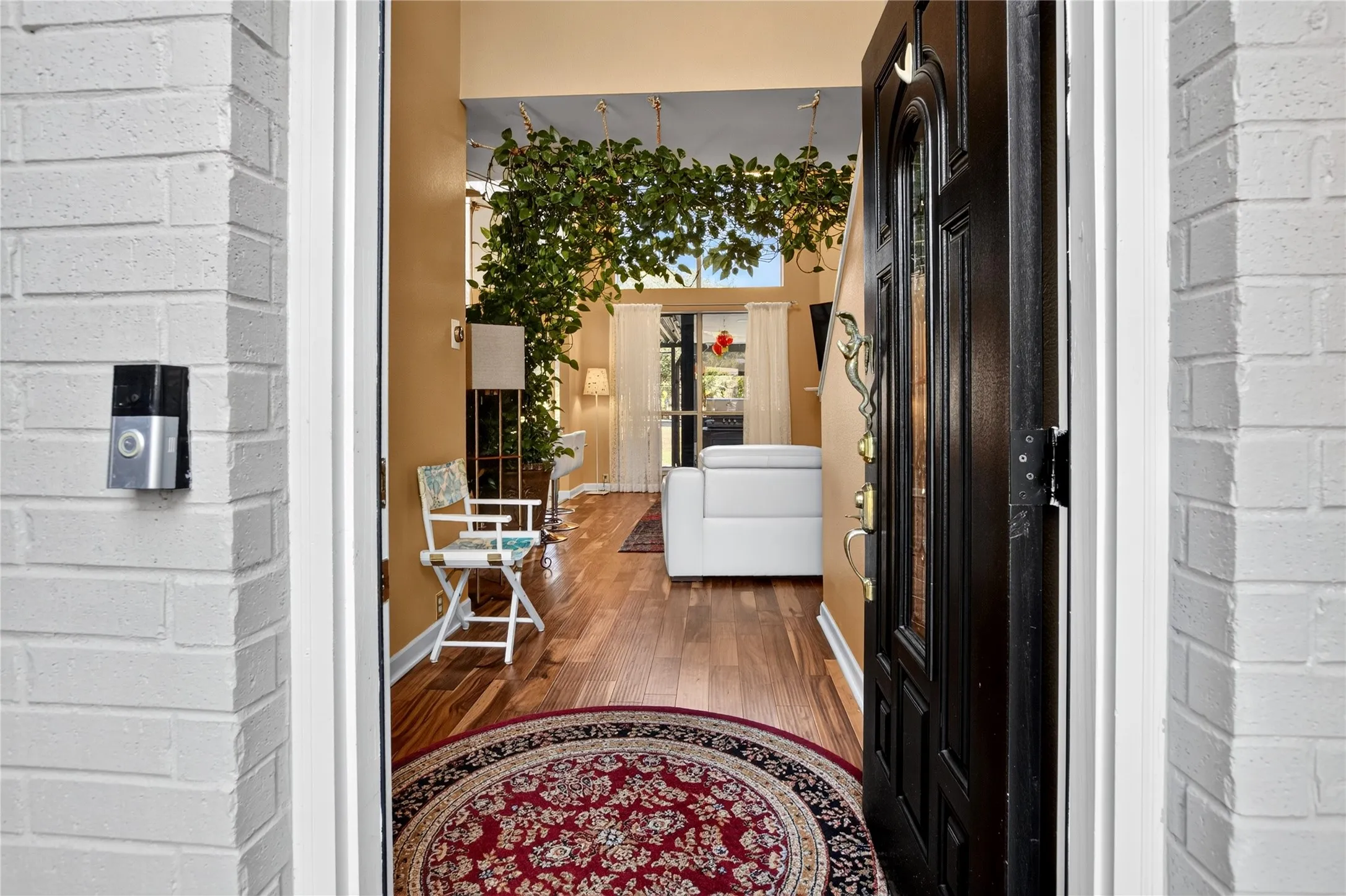 White brick exterior wall with a security doorbell