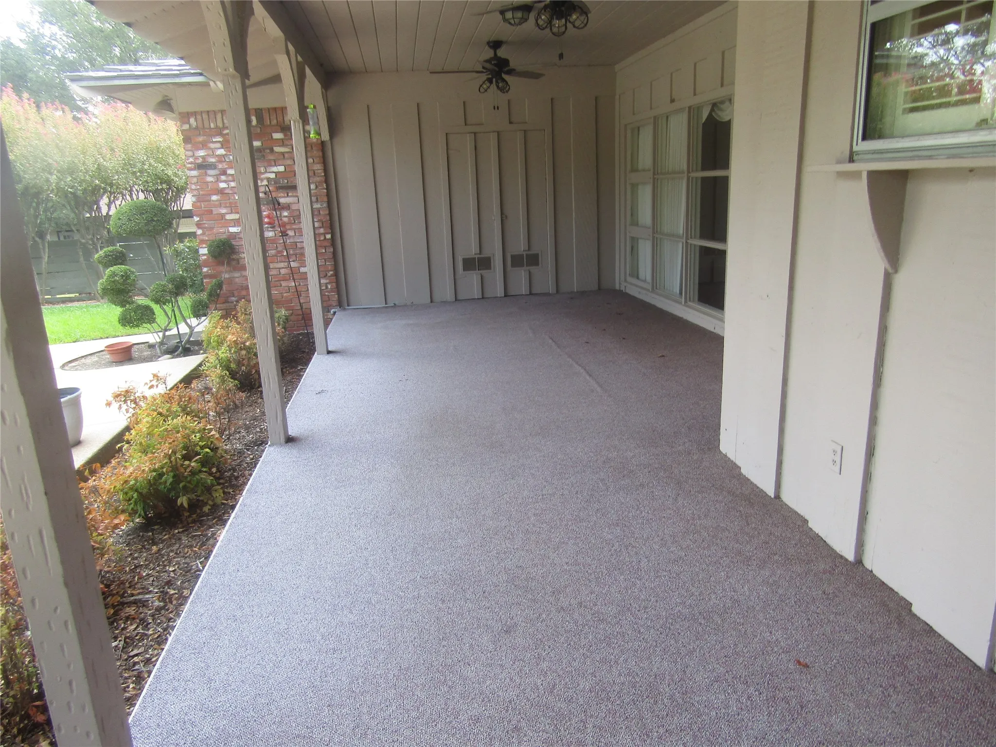 Expansive covered patio with a textured aggregate surface