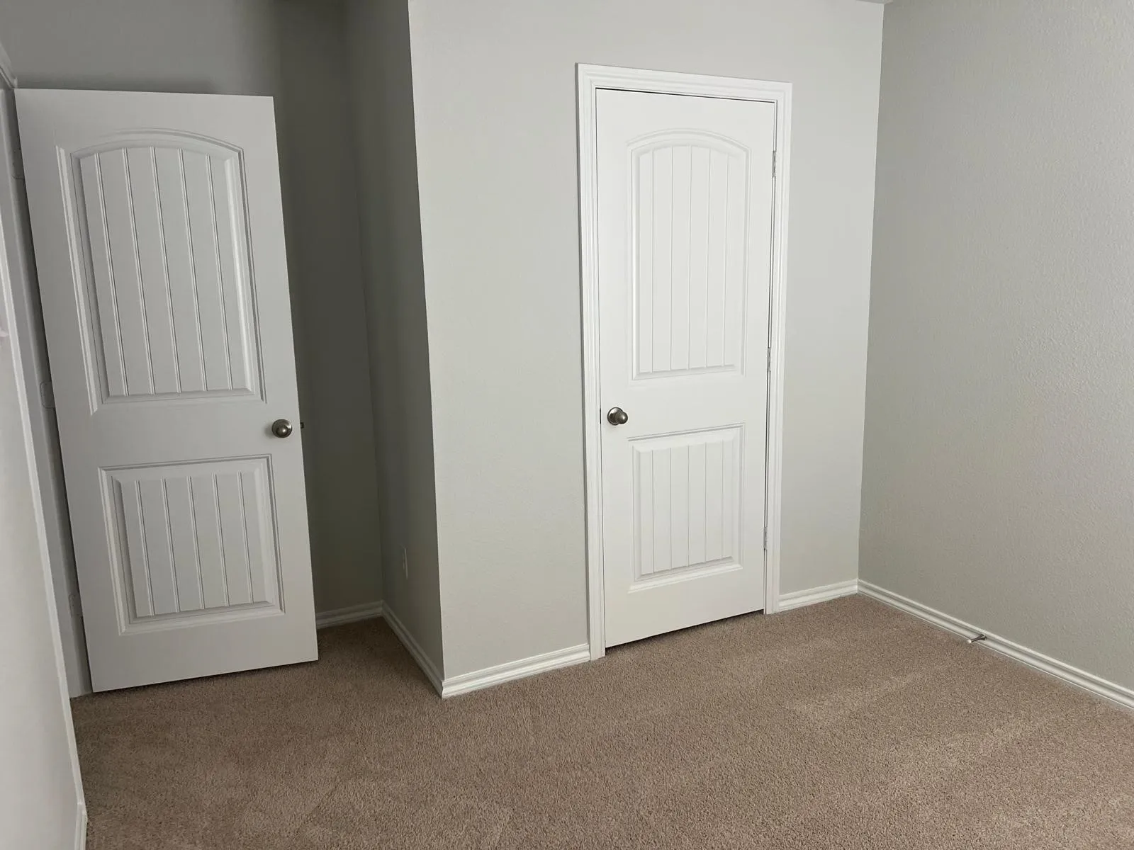 Unfurnished bedroom with carpet flooring