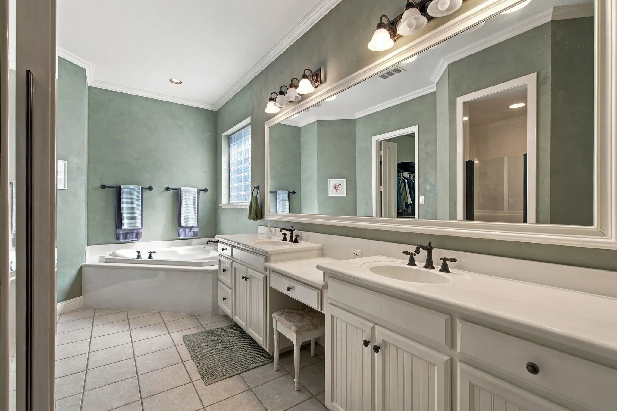 Dual vanity with white cabinetry and integrated sinks