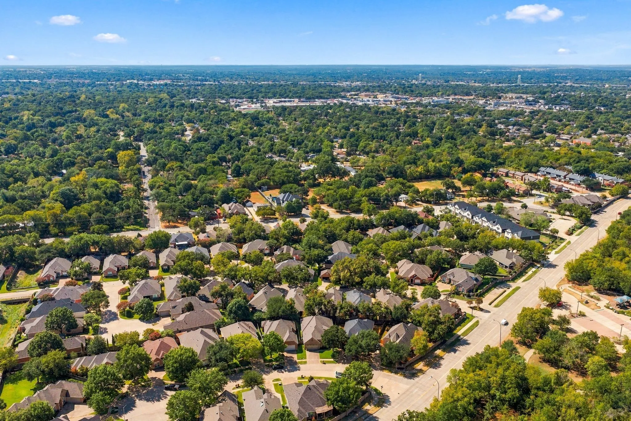 Expansive residential area with numerous single-family homes, mature tree canopy, and established infrastructure