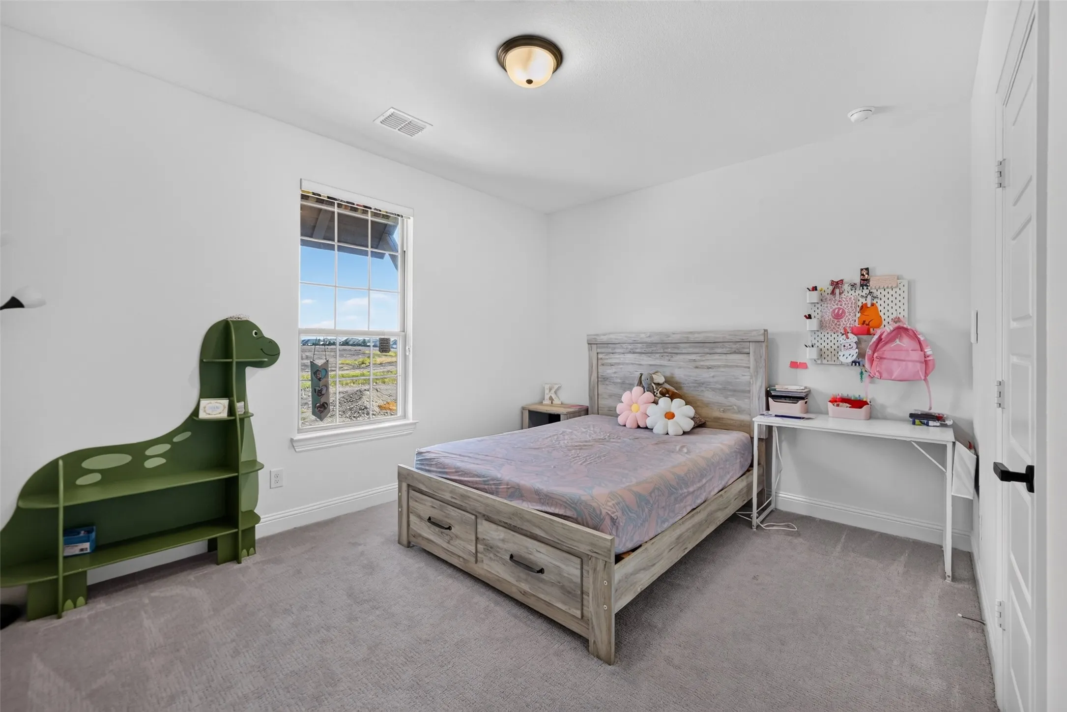 Recessed lighting, light gray carpeting, white walls, and a white interior door with black hardware